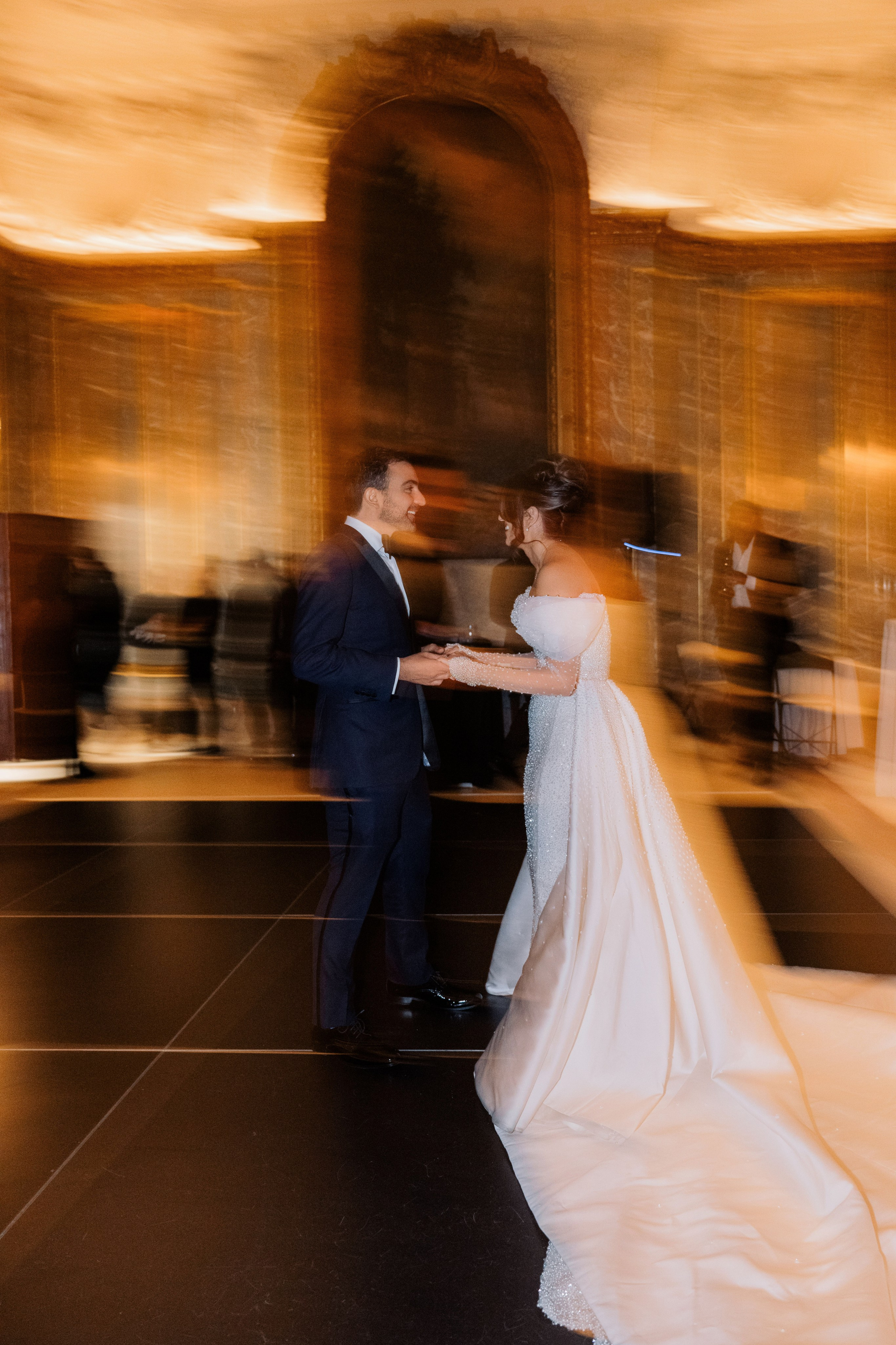 a bride and groom are standing in a room