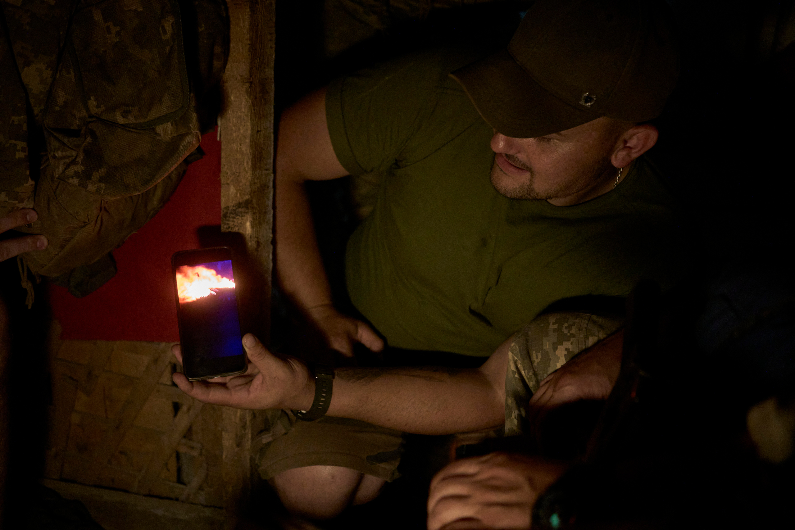 Soldier, callsign "Ara", showing video from battlefield in the shelter.