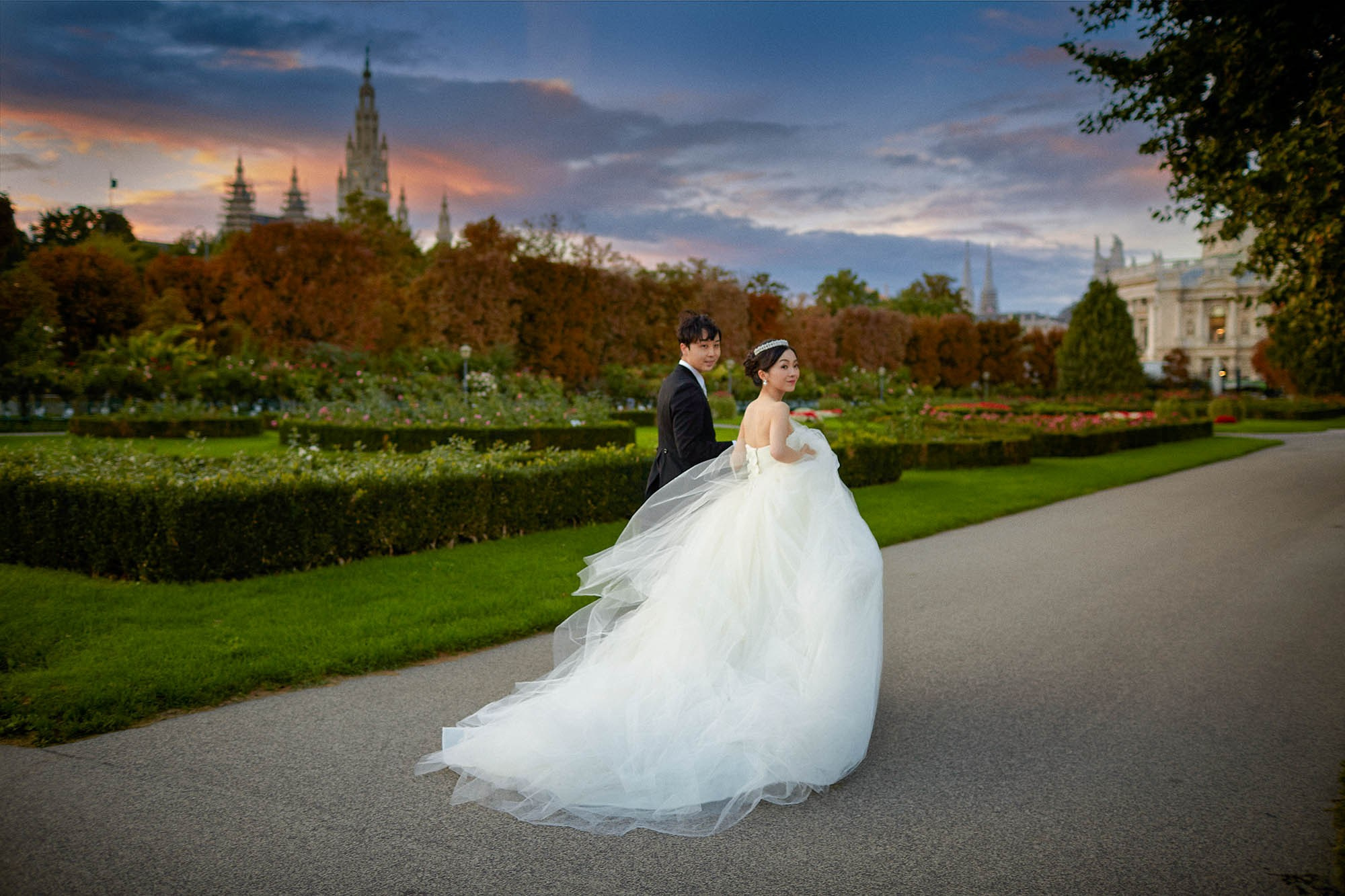 Bride looking back with dress contrasting twilight sky Volksgarten.