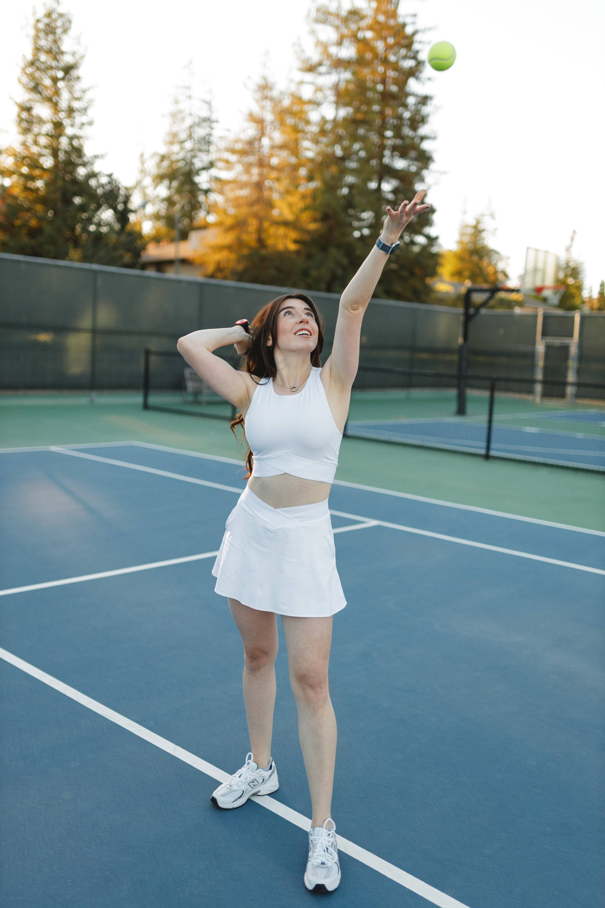 Woman playing tennis during golden hour photoshoot in Bay Area
