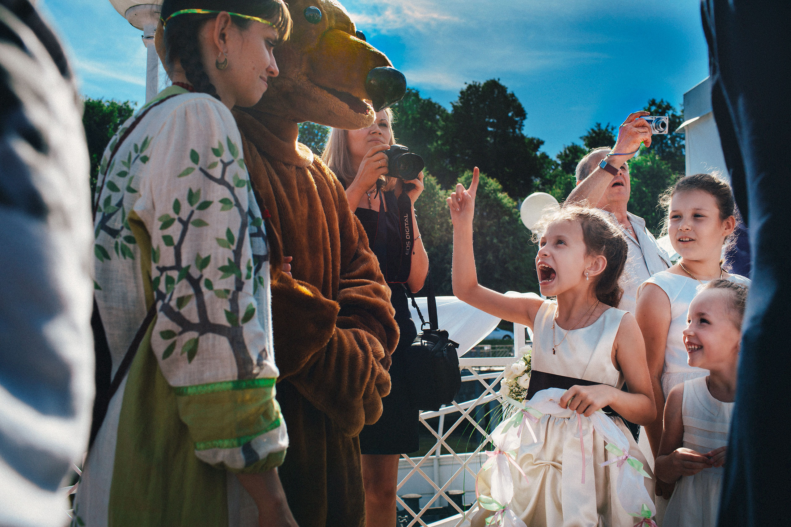 Reportage photo of kids and a plush bear at wedding reception