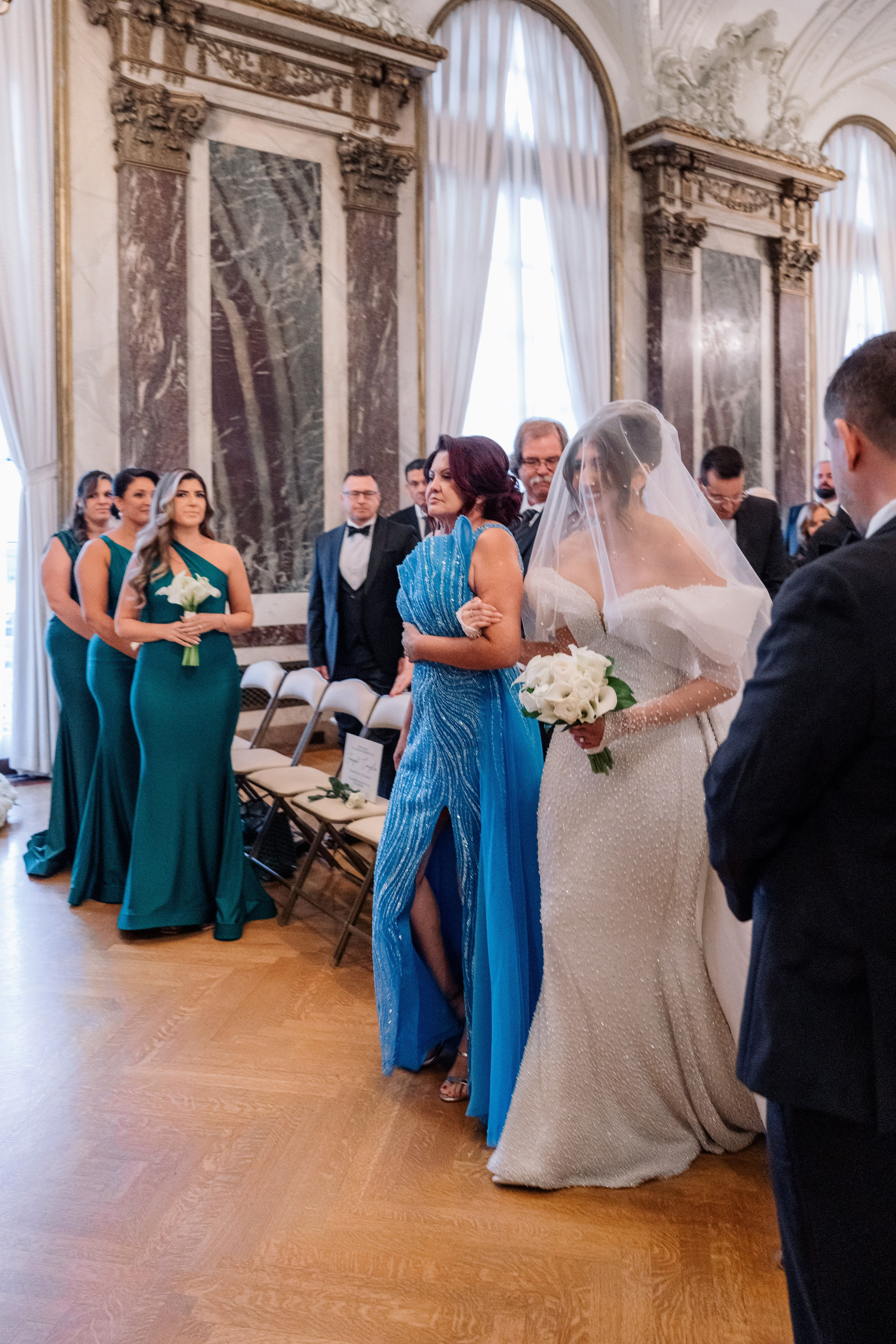 a bride and groom are walking down the aisle