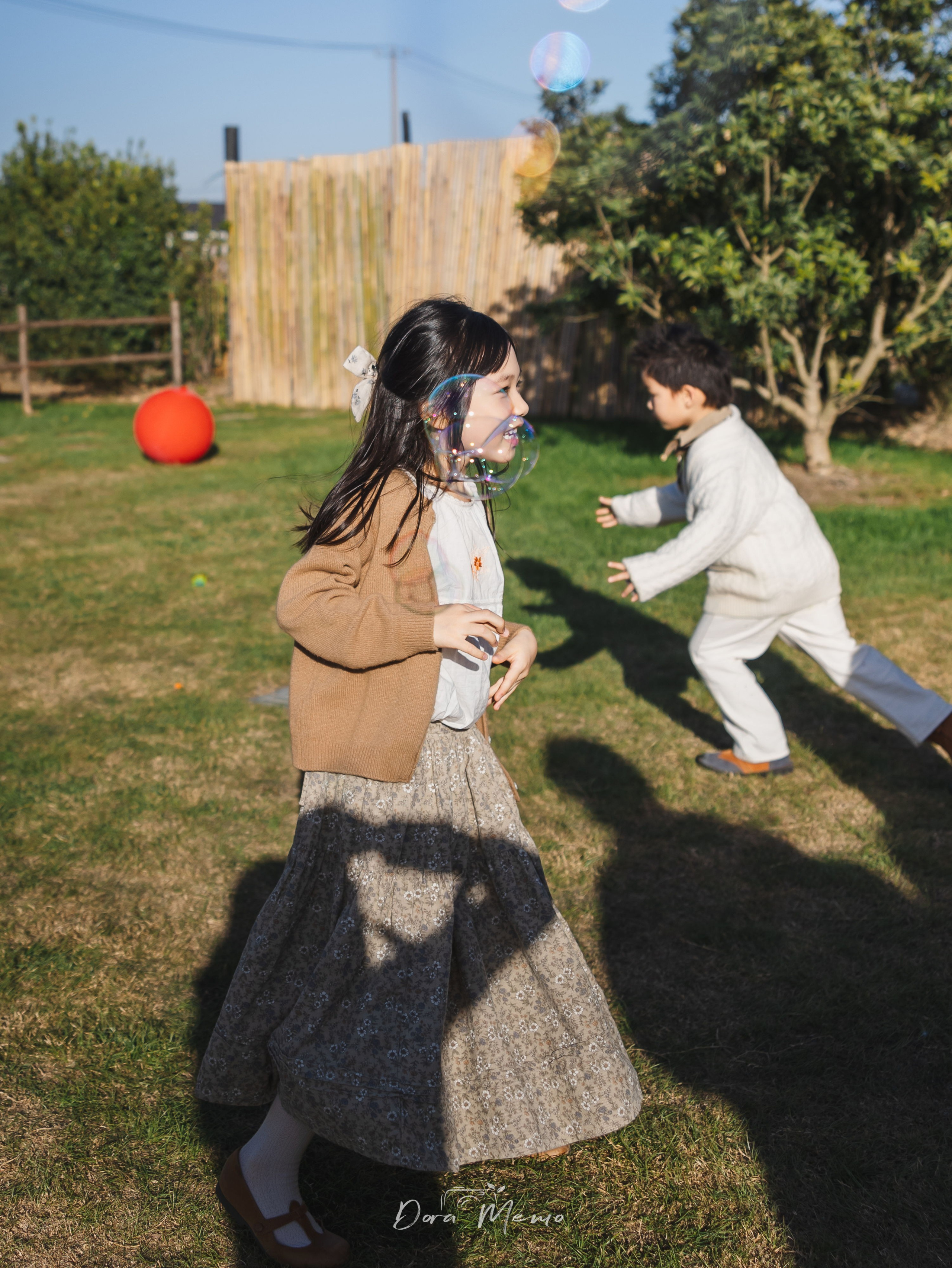 Shanghai documentary family photography - girl playing with bubbles, joyful expression at birthday party