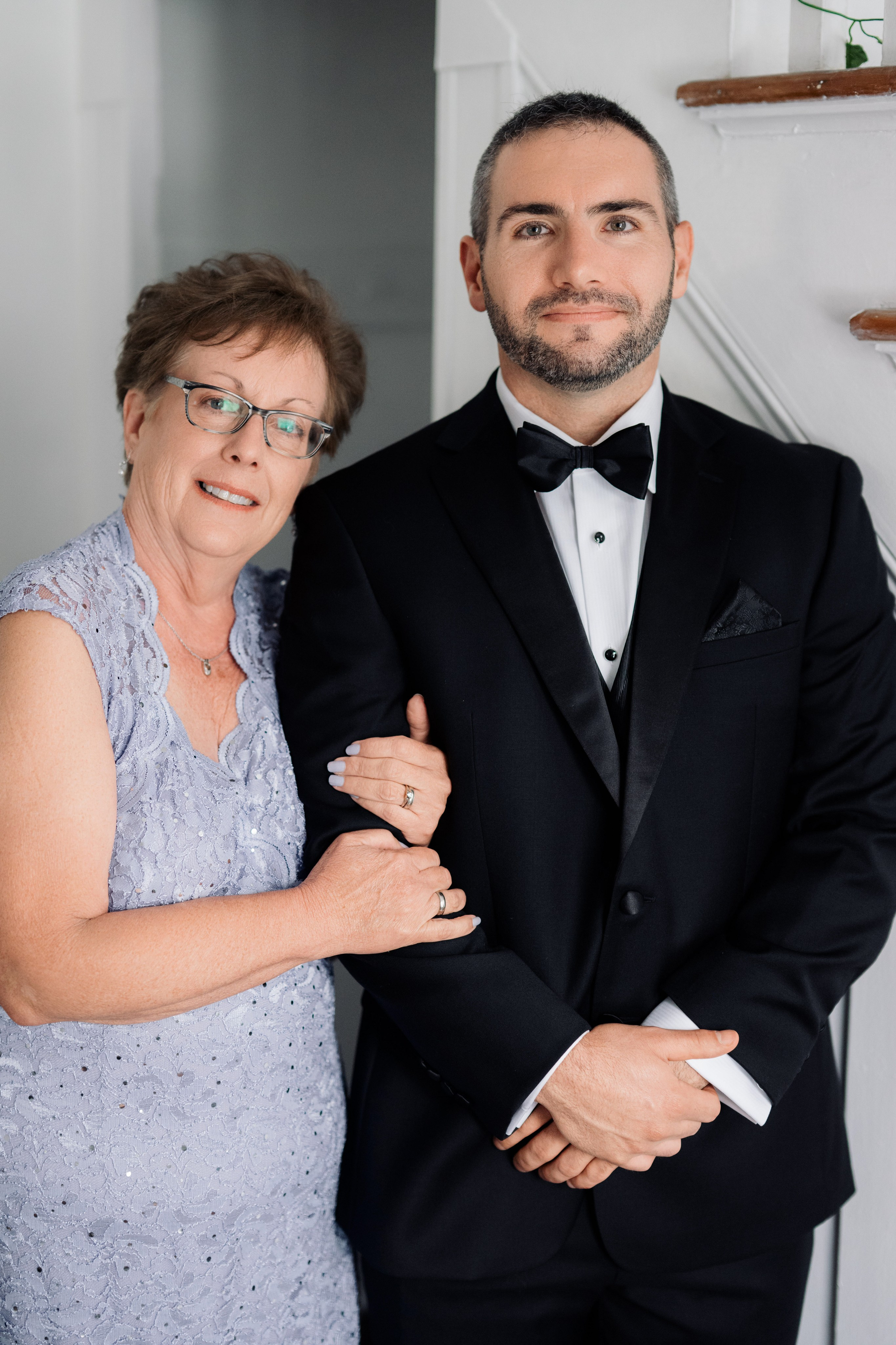 a man and woman in formal attire posing for a picture