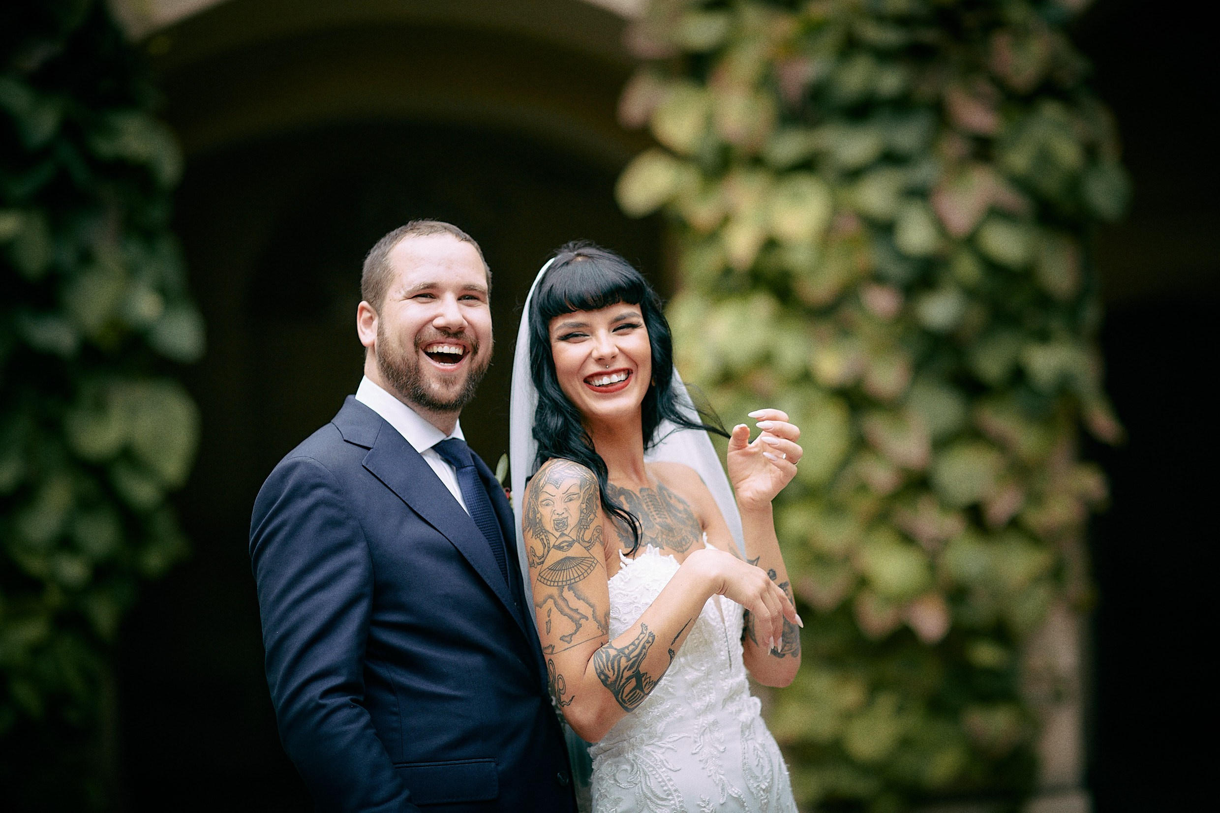 Couple laughing joyfully in historic Grebovka vineyard grotto Prague.