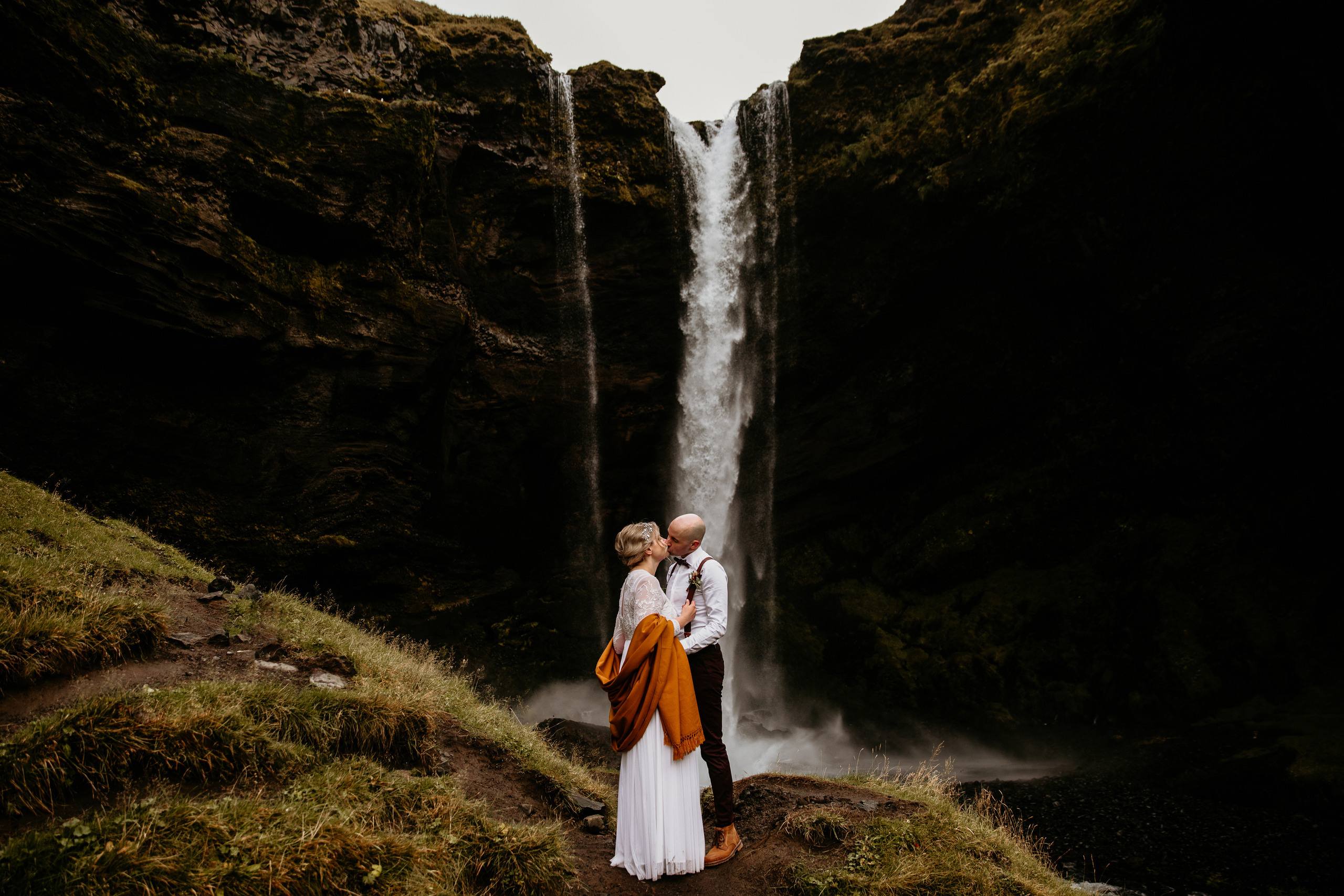 couple in front of waterfall Iceland