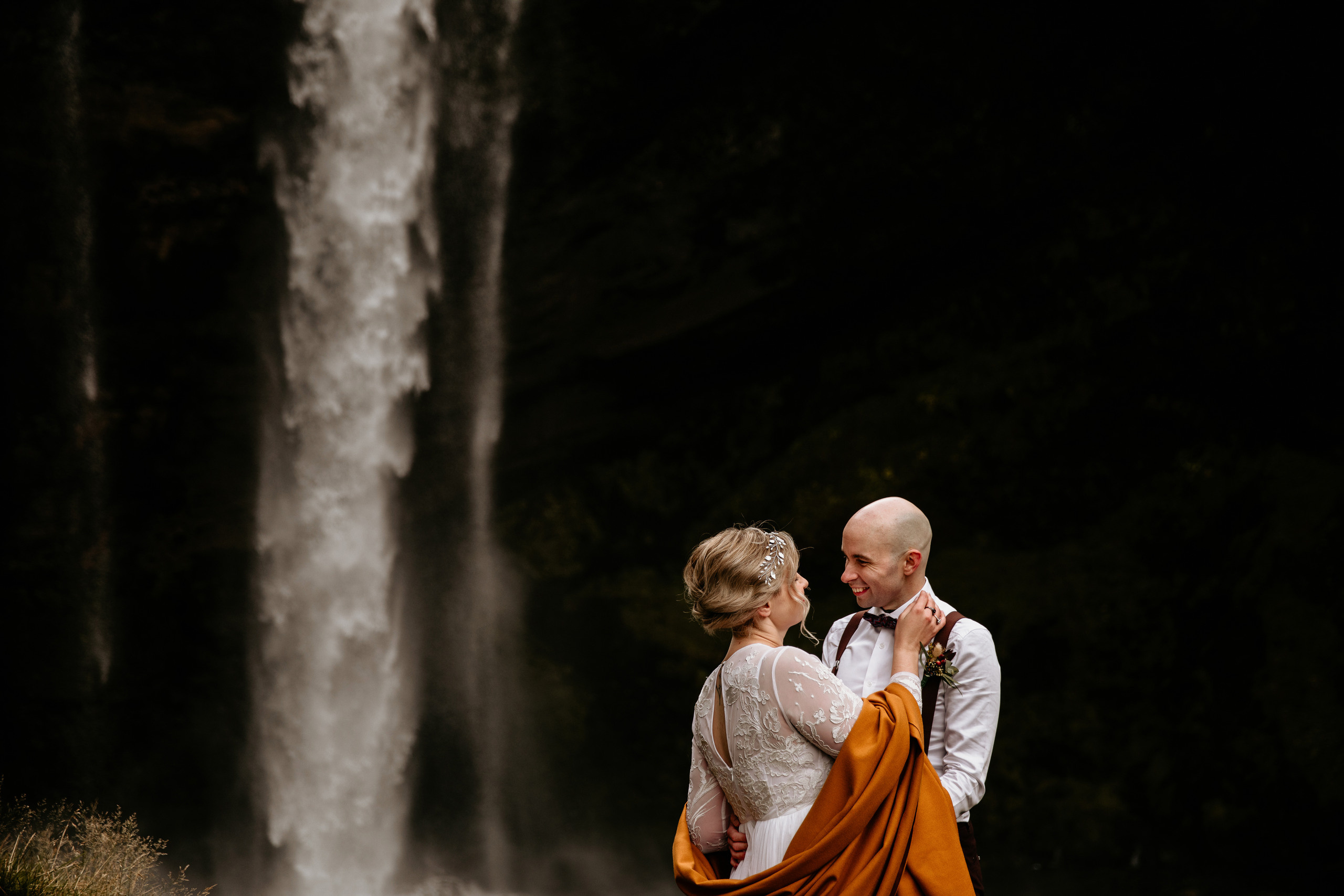 couple in front of waterfall Iceland