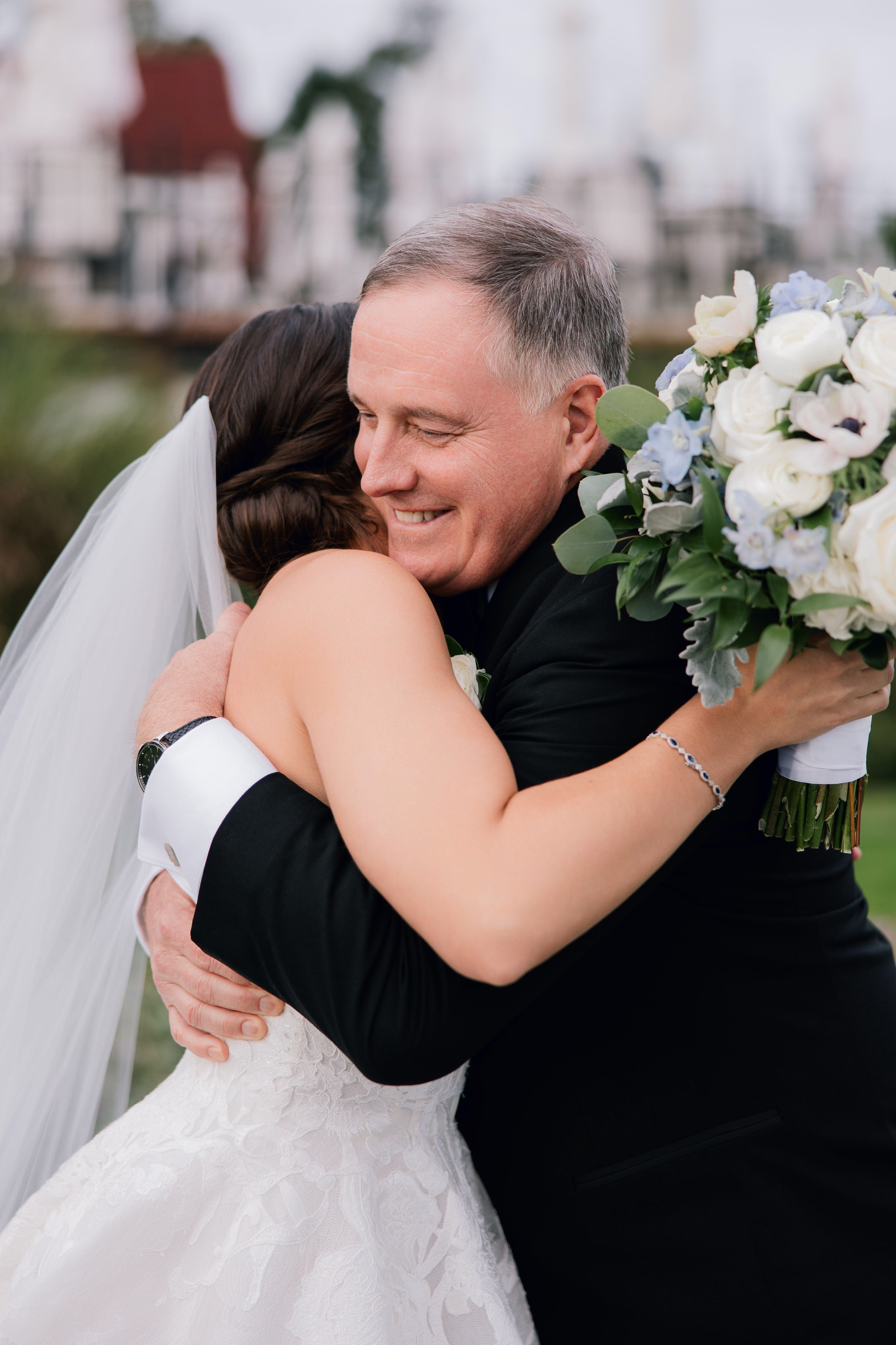a bride and groom hugging each other brides