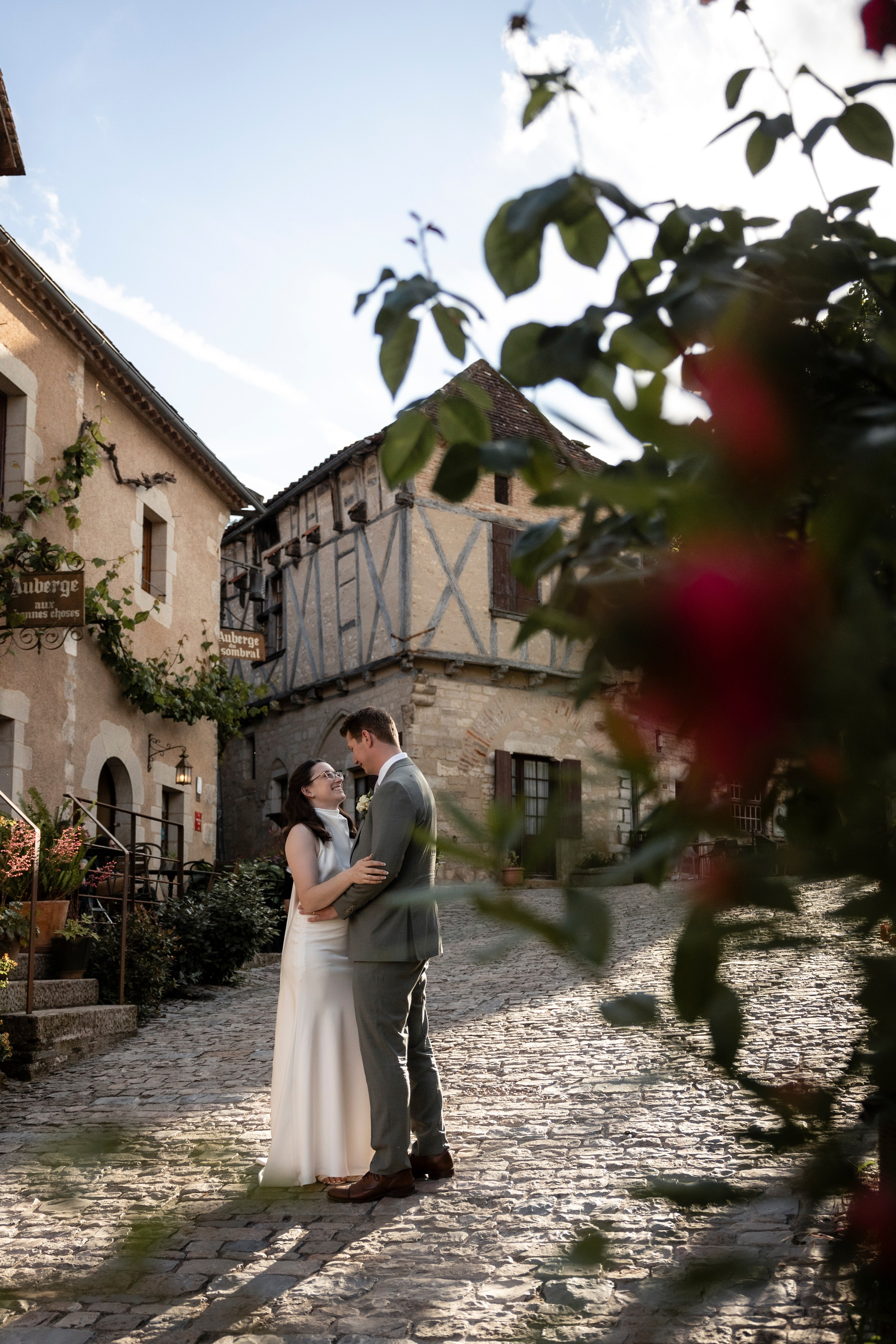 Bride and groom in the medieval village of Saint-Cirq-Lapopie at golden hour