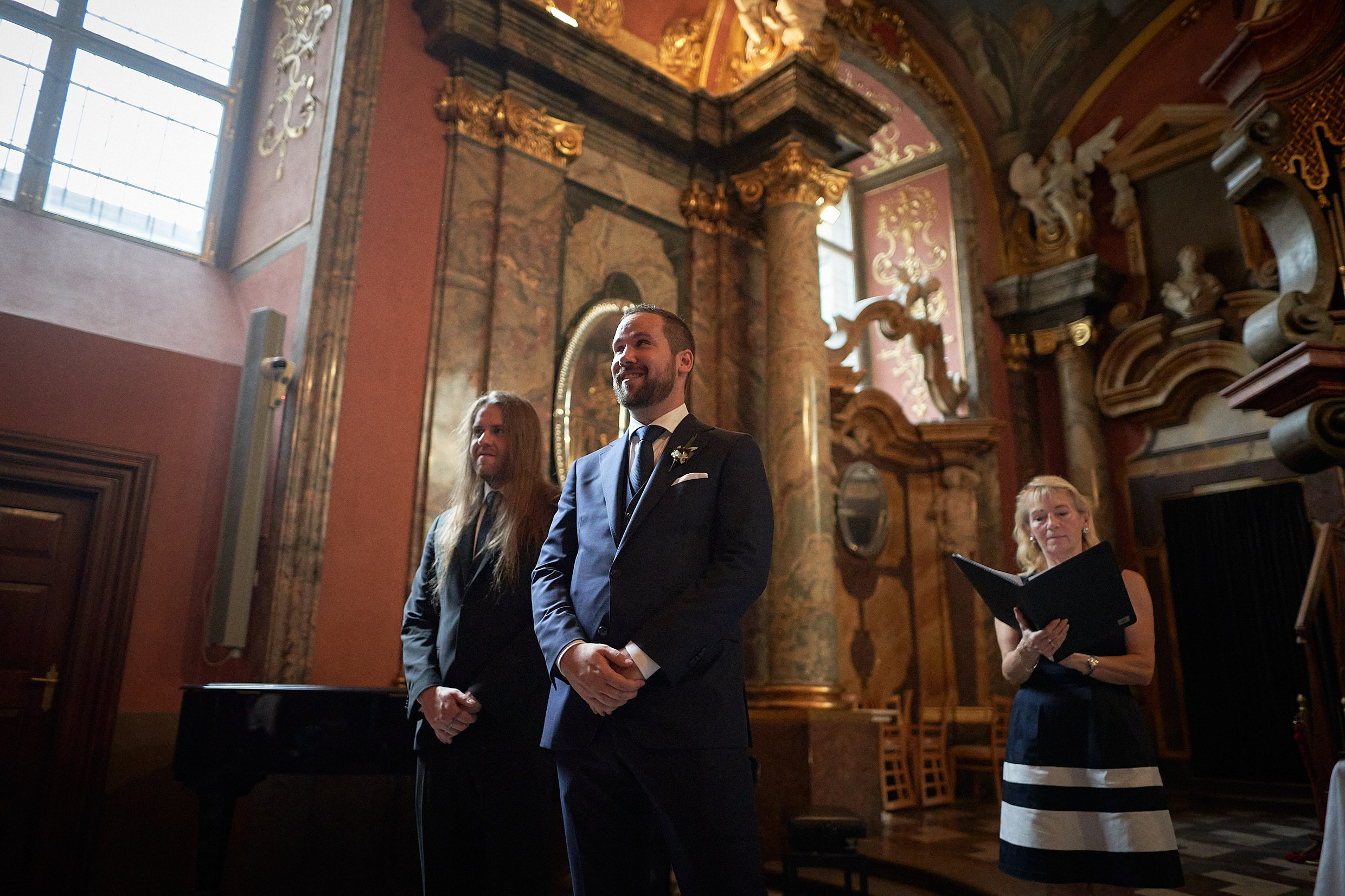 Groom waiting nervously at altar in historic Mirror Chapel Prague.