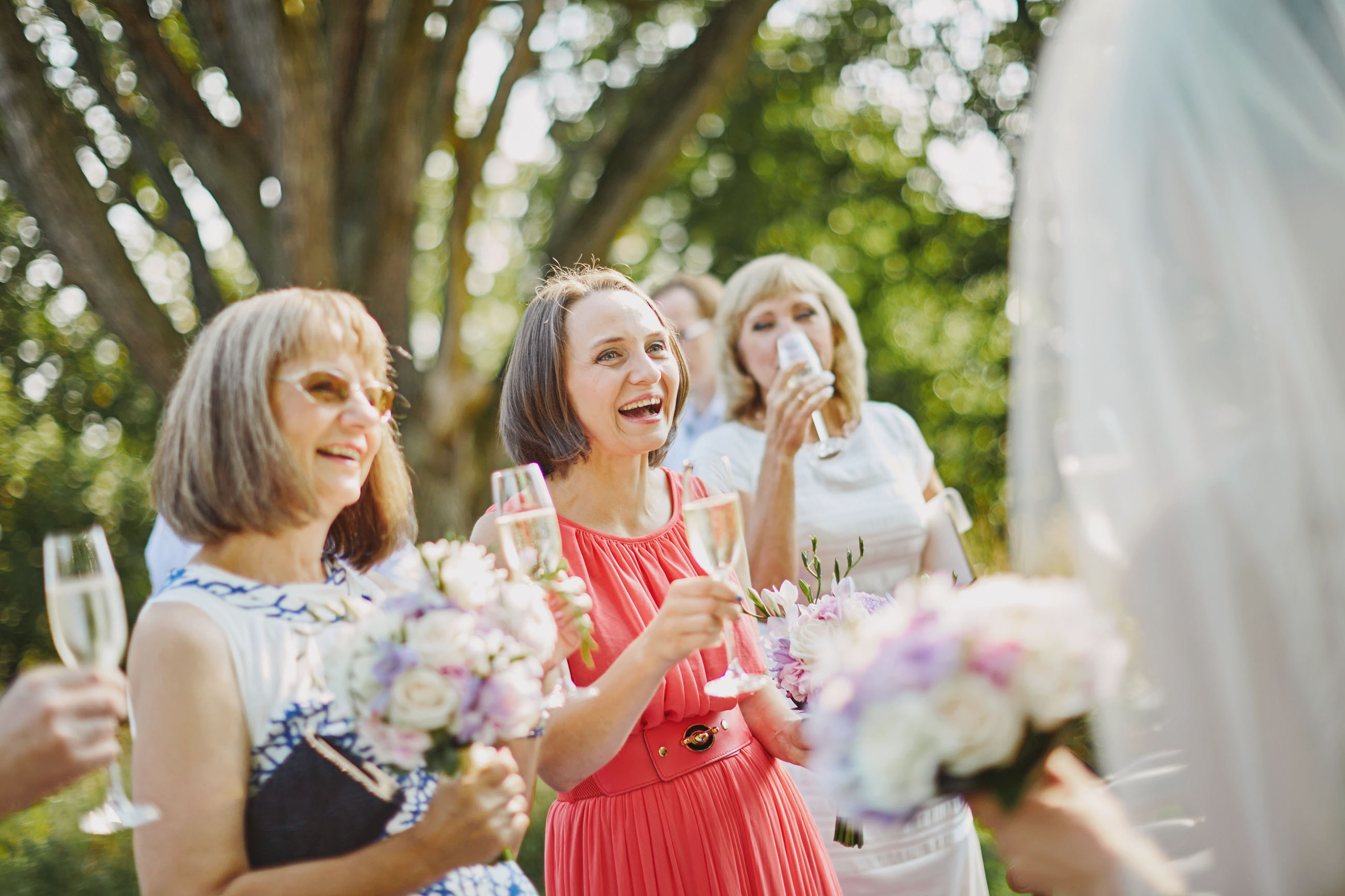 Family and guests toasting with champagne at chateau wedding celebration.