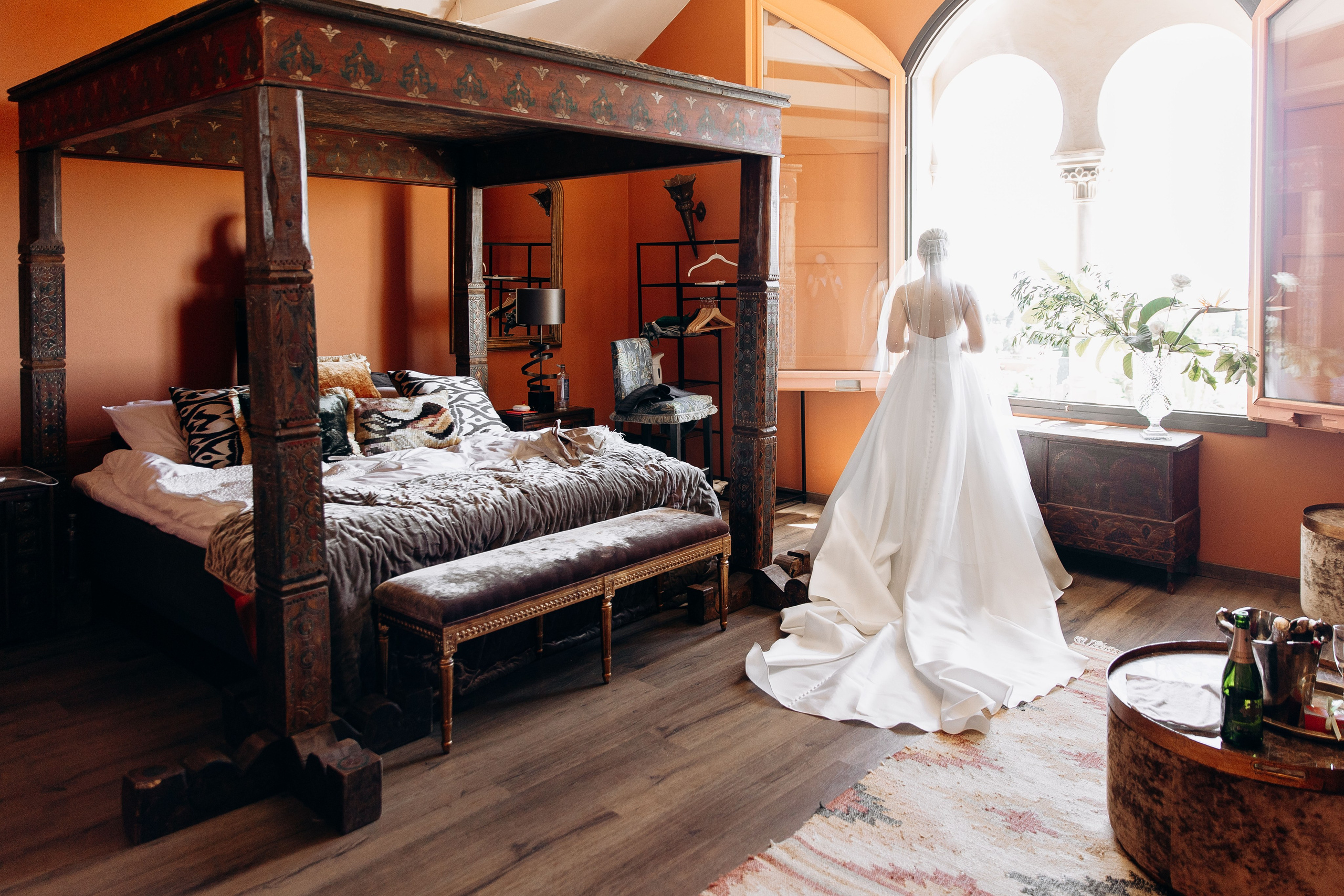 Dressed bride is observing the lush gardens of Gran Villa Rosa