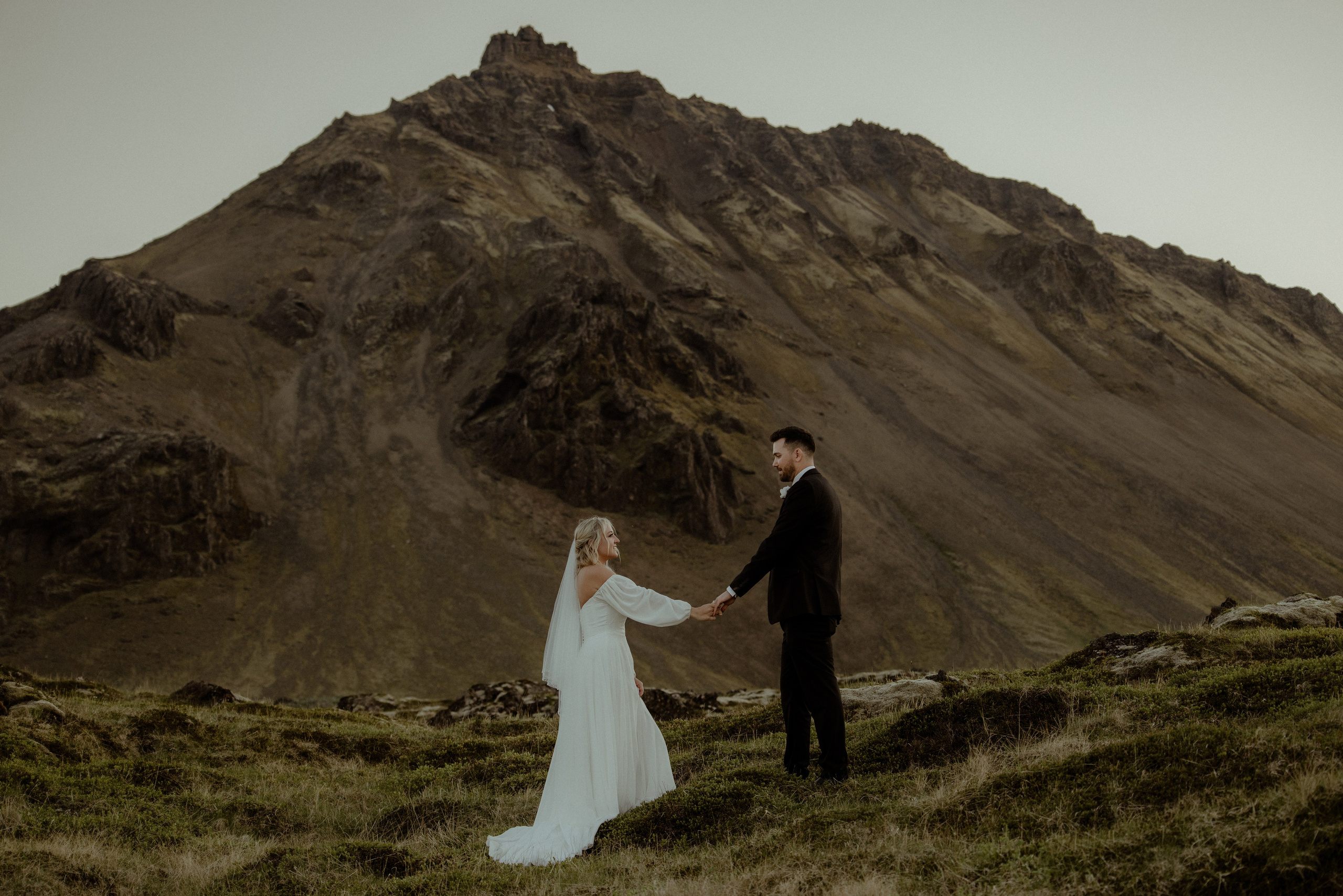 Iceland elopement at Budir with midnight sun wedding photos at black sand beach. Iceland elopement photographer & videographer