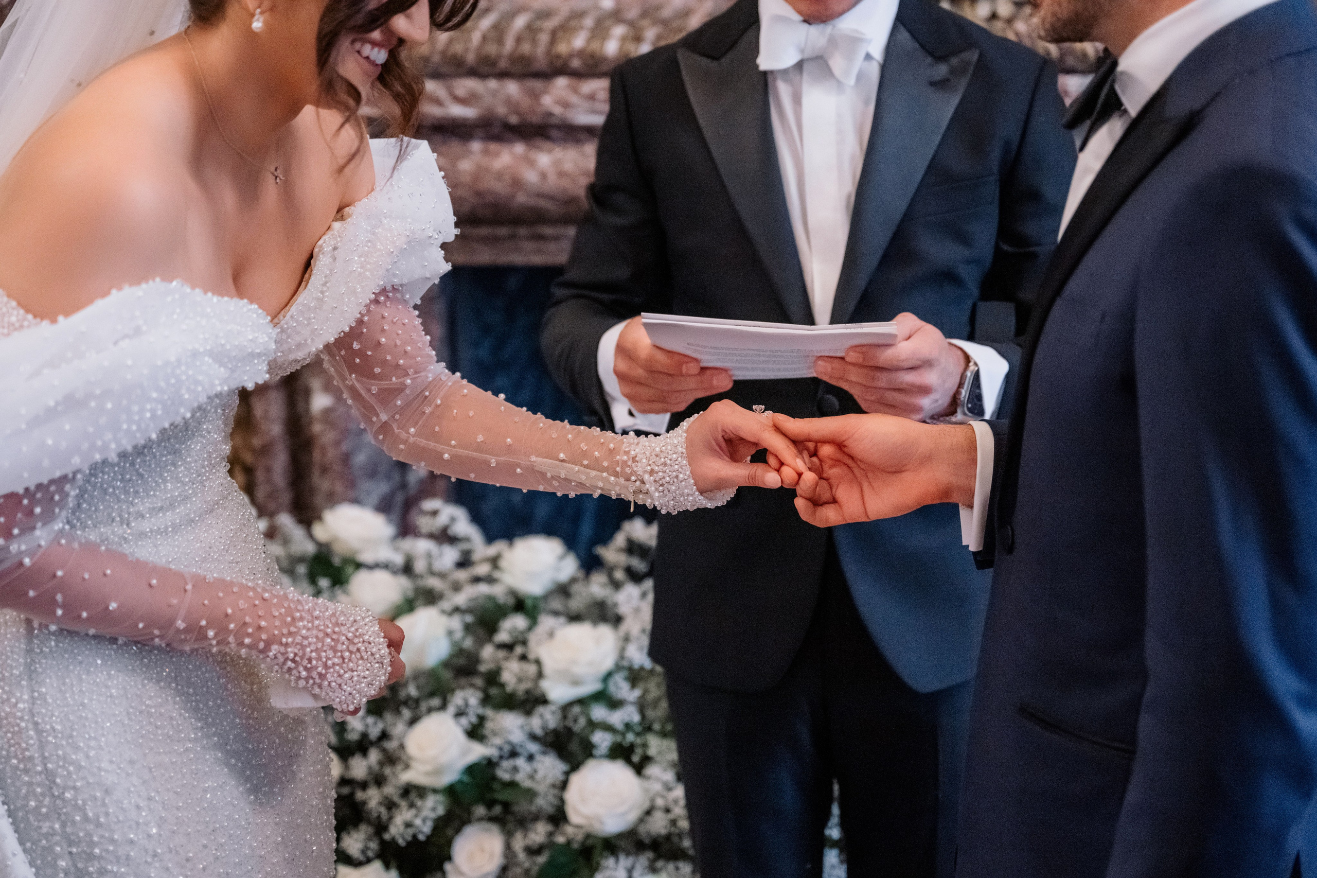 a man and woman exchanging a wedding ring