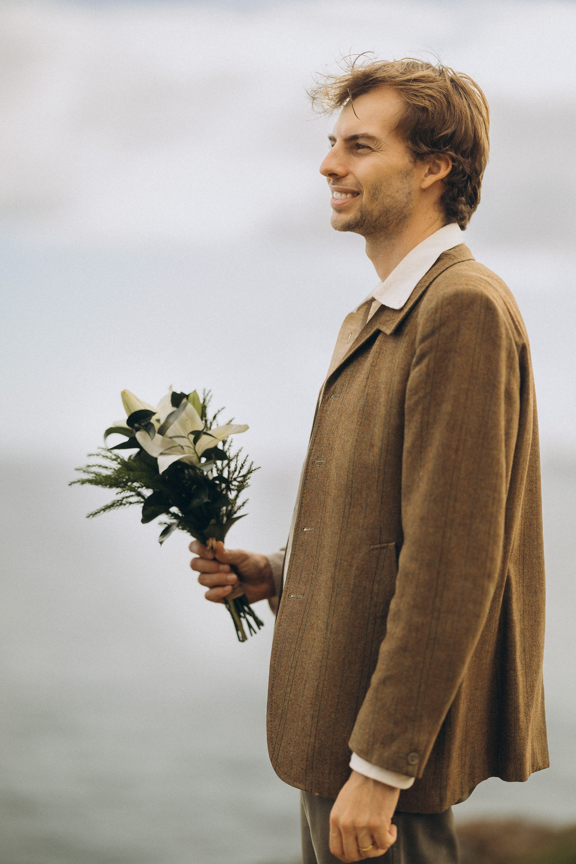 Romantic elopement in Madeira — couple exchanging vows with Atlantic Ocean views.
