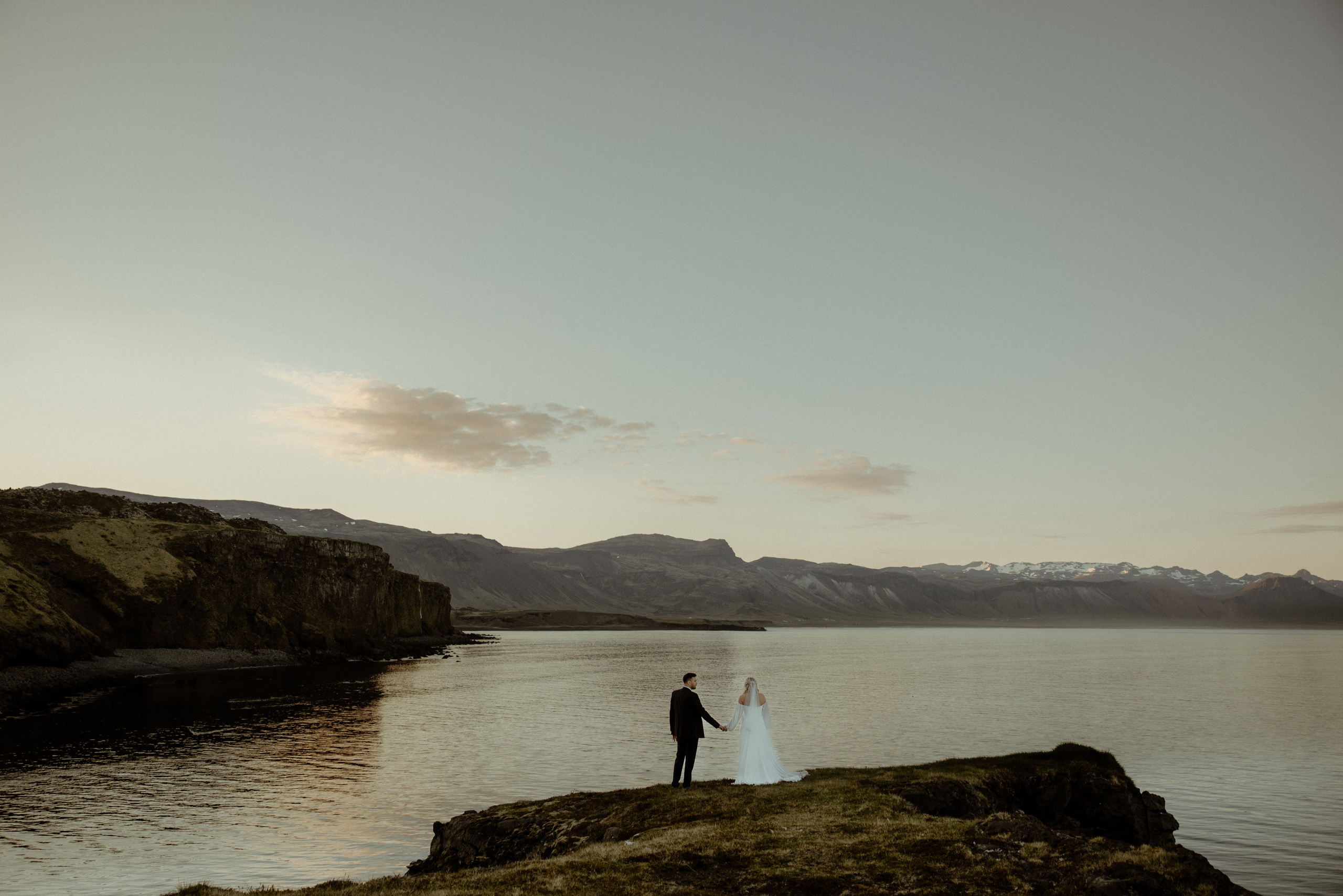 Iceland elopement at Budir with midnight sun wedding photos at black sand beach. Iceland elopement photographer & videographer