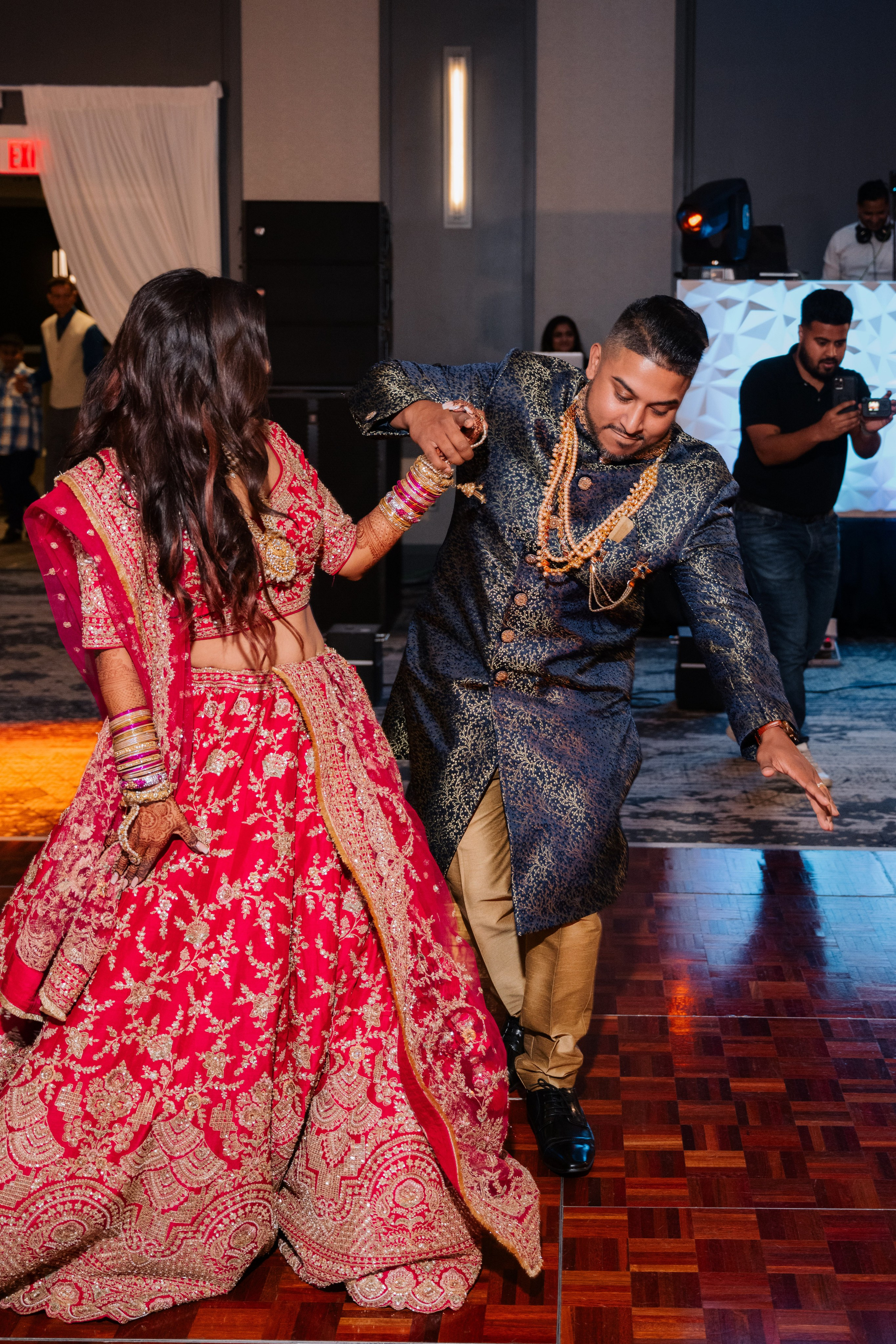 a man and woman dancing on a wooden floor