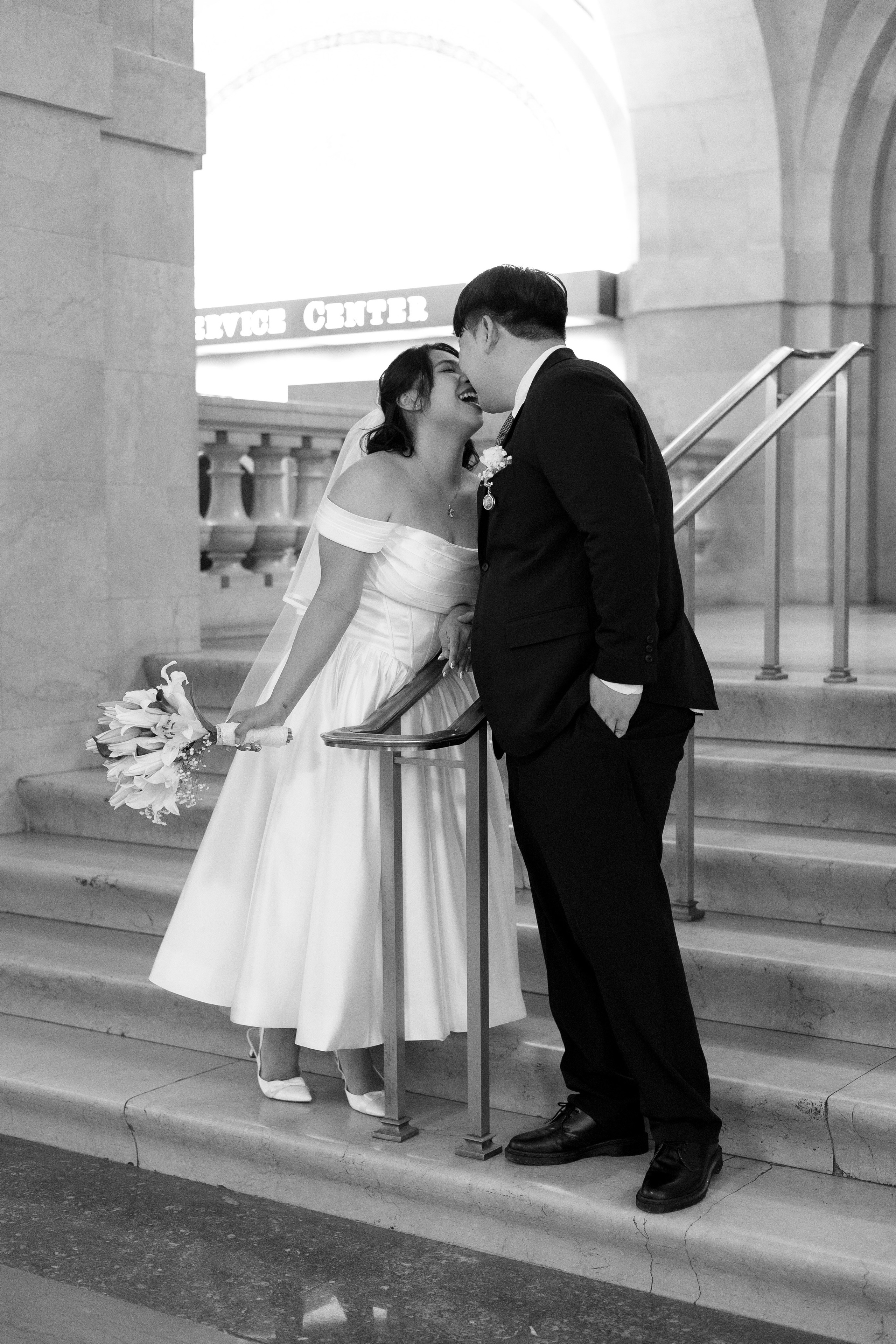 Couple kissing on the steps inside Chicago City Hall