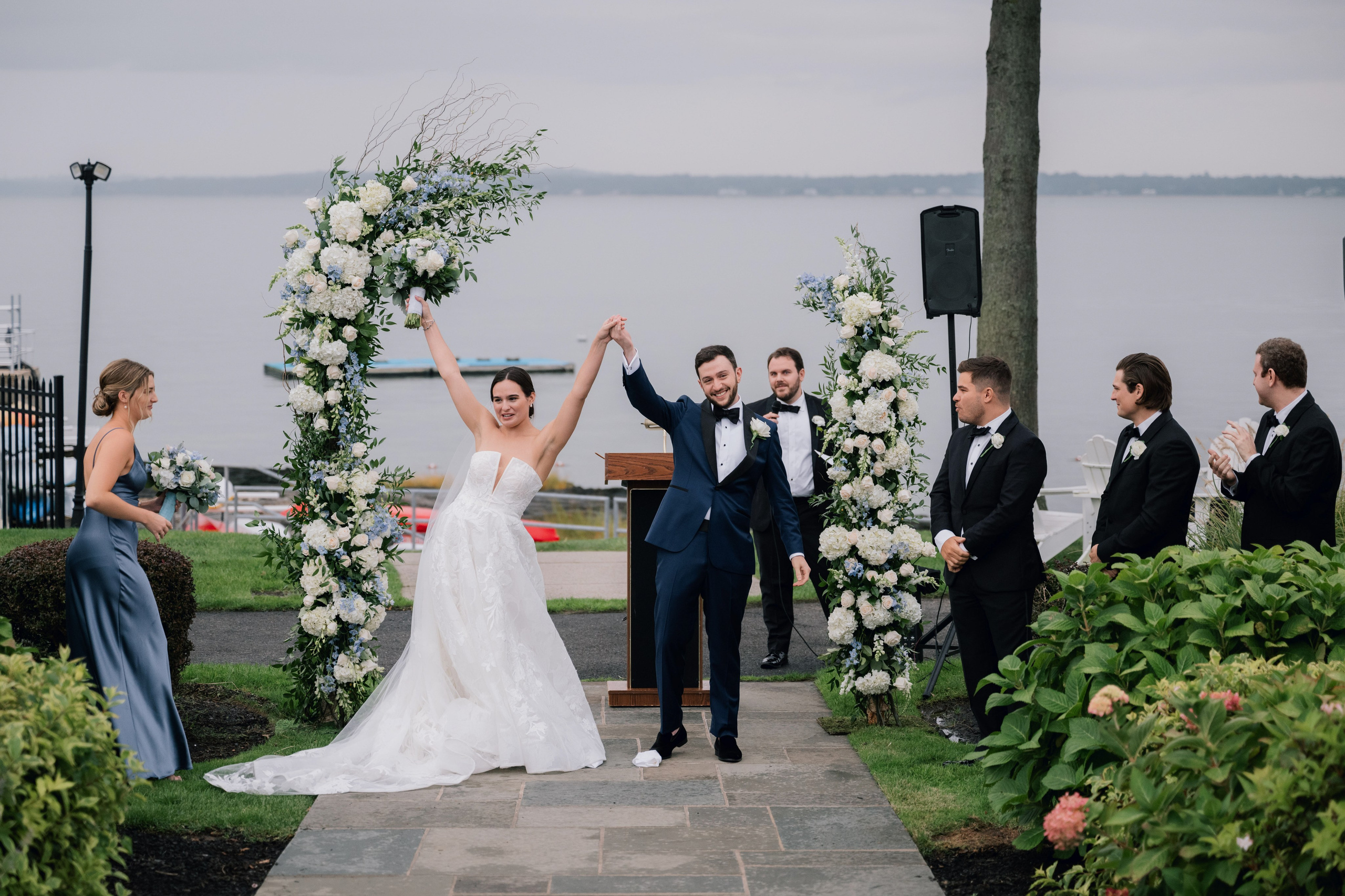 a bride and groom are walking down the aisle