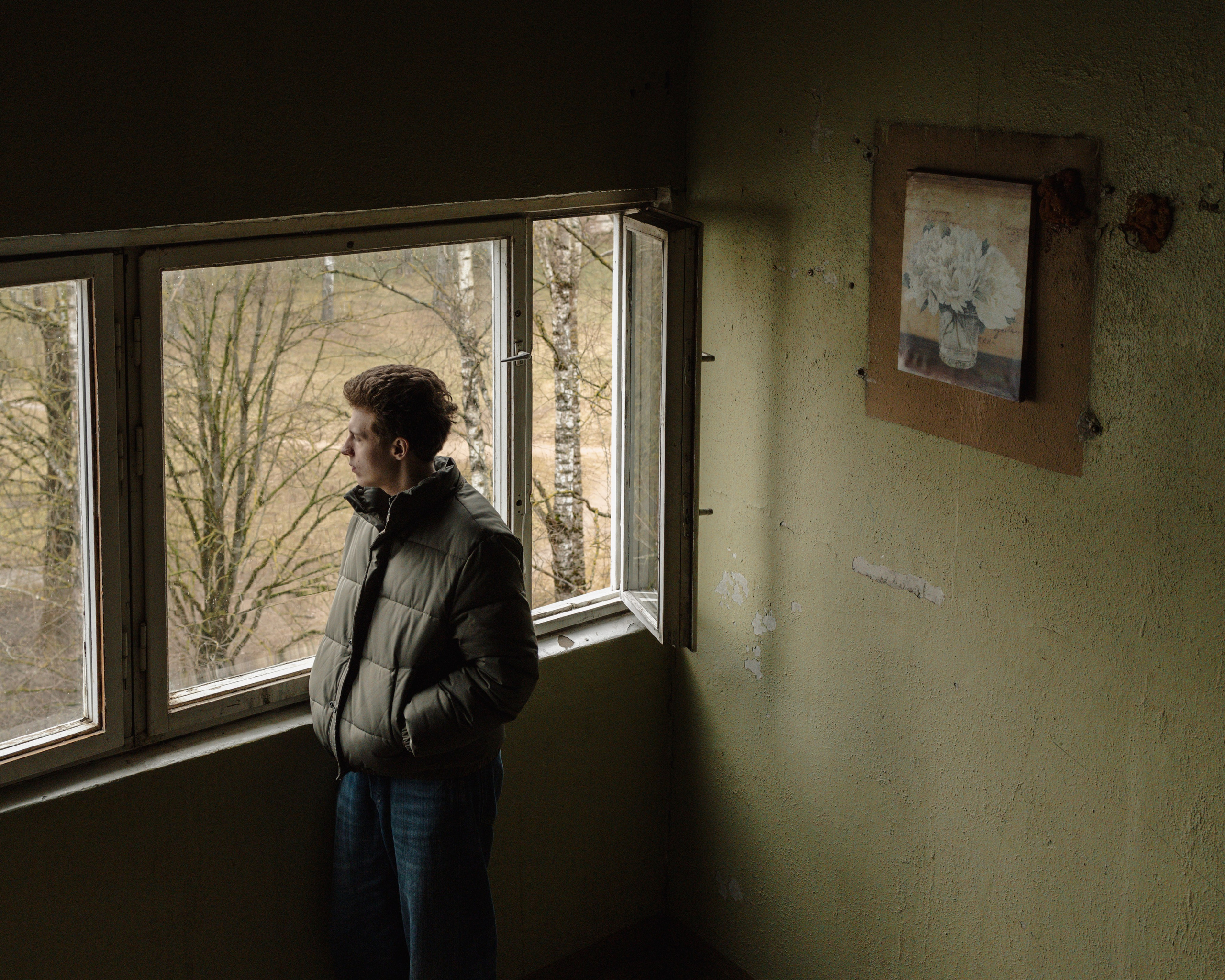 Marks Burja, in his apartment building in Cukurfabrika, a small city near Riga. He studied computer engineering but now works in a casino. Like Marks, many graduates in Latvia find themselves in jobs unrelated to their field of study, often due to a lack of experience or skills demanded by employers. Mark's experience also underscores a sense of disillusionment, as he discovered his interests lie more in social interaction than in the tech field he initially pursued.