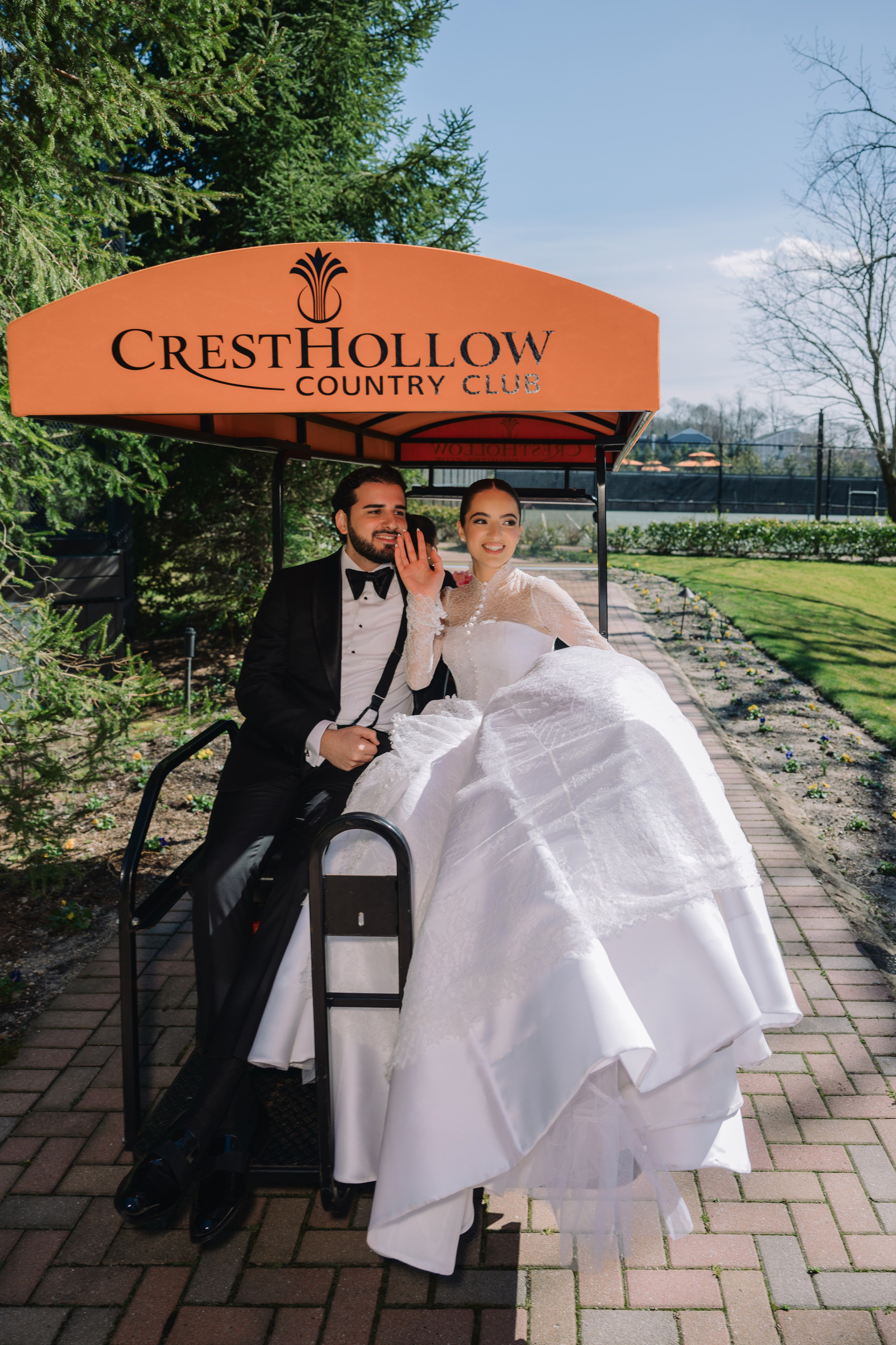 a bride and groom pose under an umbrella