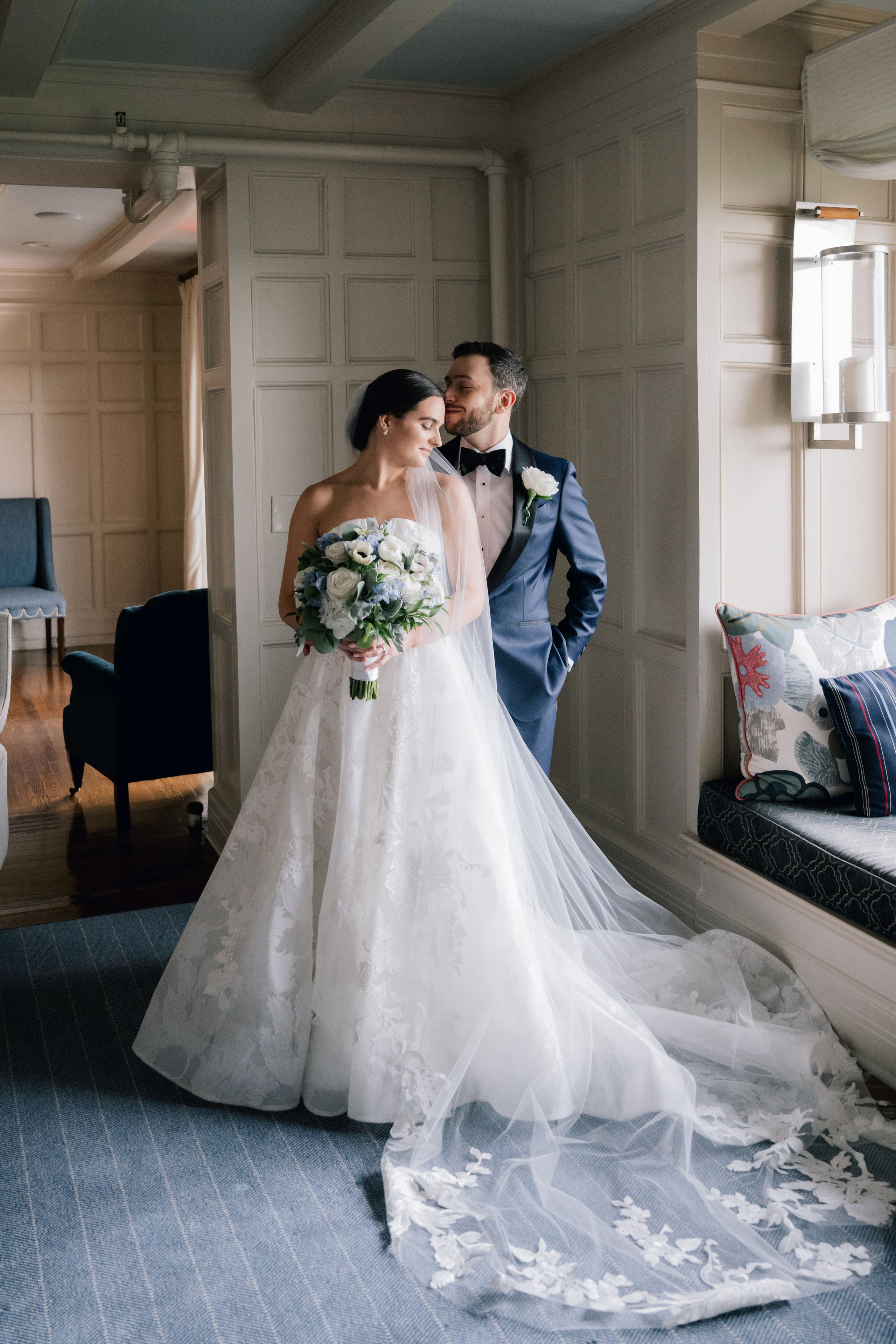 a bride and groom pose for a photo in a hotel room