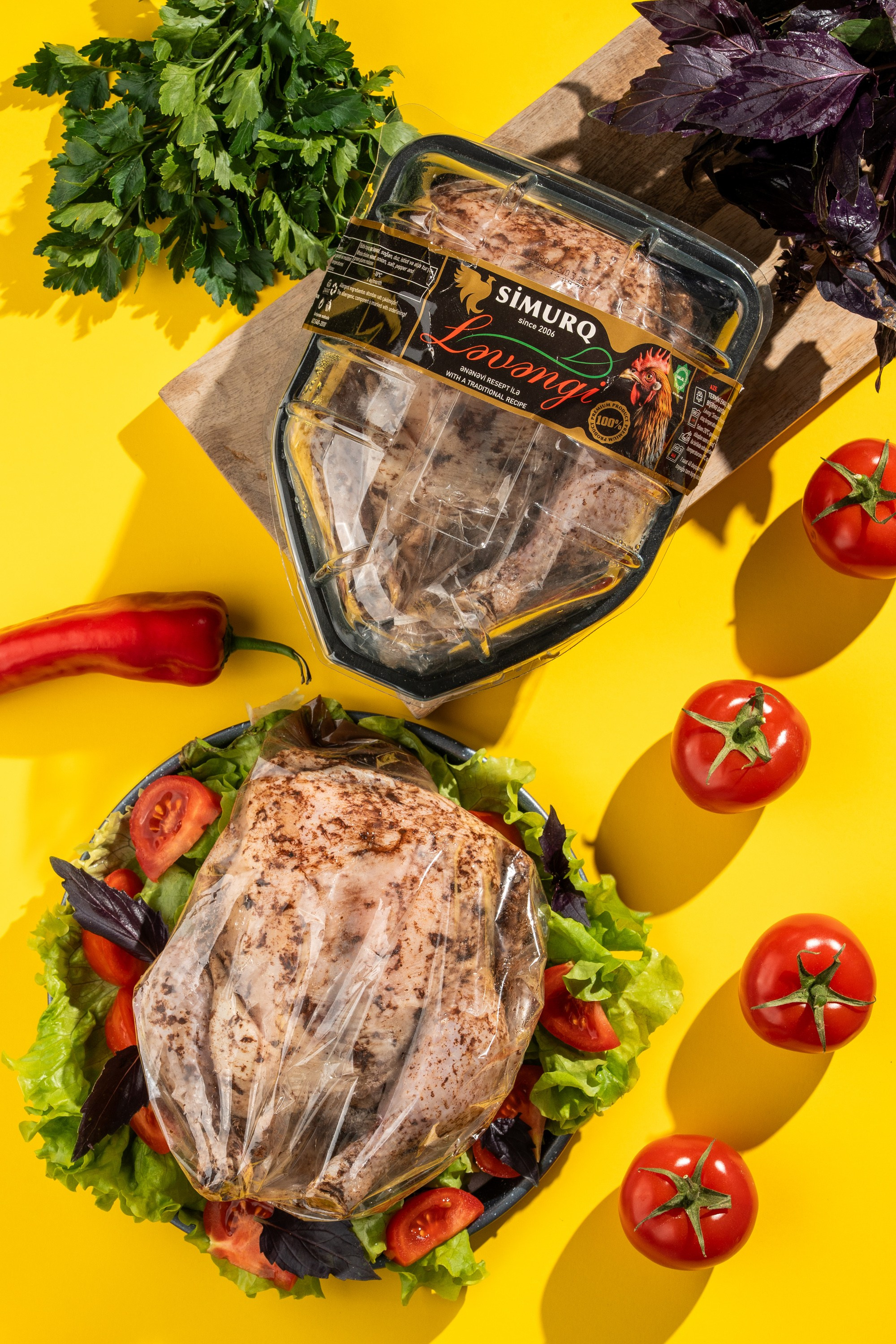 Simurq Ləvəngi toyuq məhsulu qablaşdırmada və salatlıqda təqdim olunmuş formada – sarı fonda tərəvəzlərlə kreativ məhsul vizualı