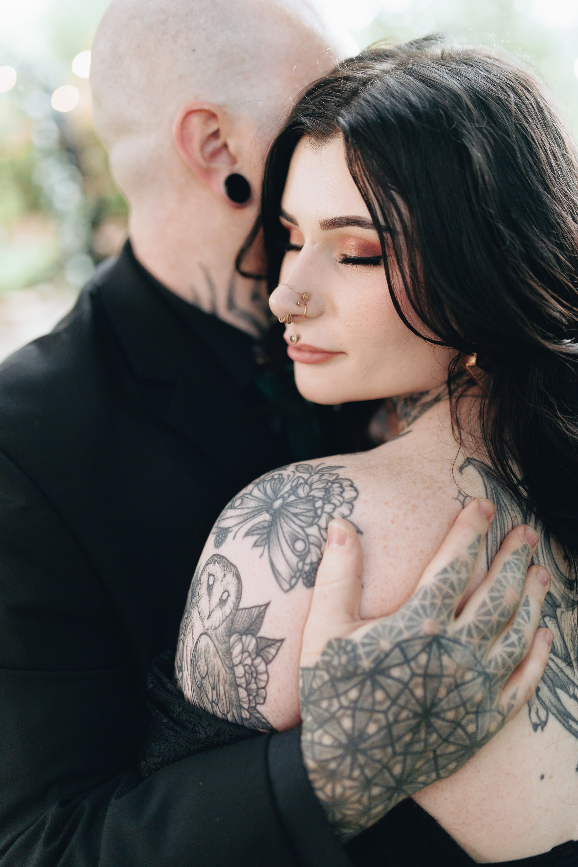 Tattooed couple hugging, alternative wedding portrait