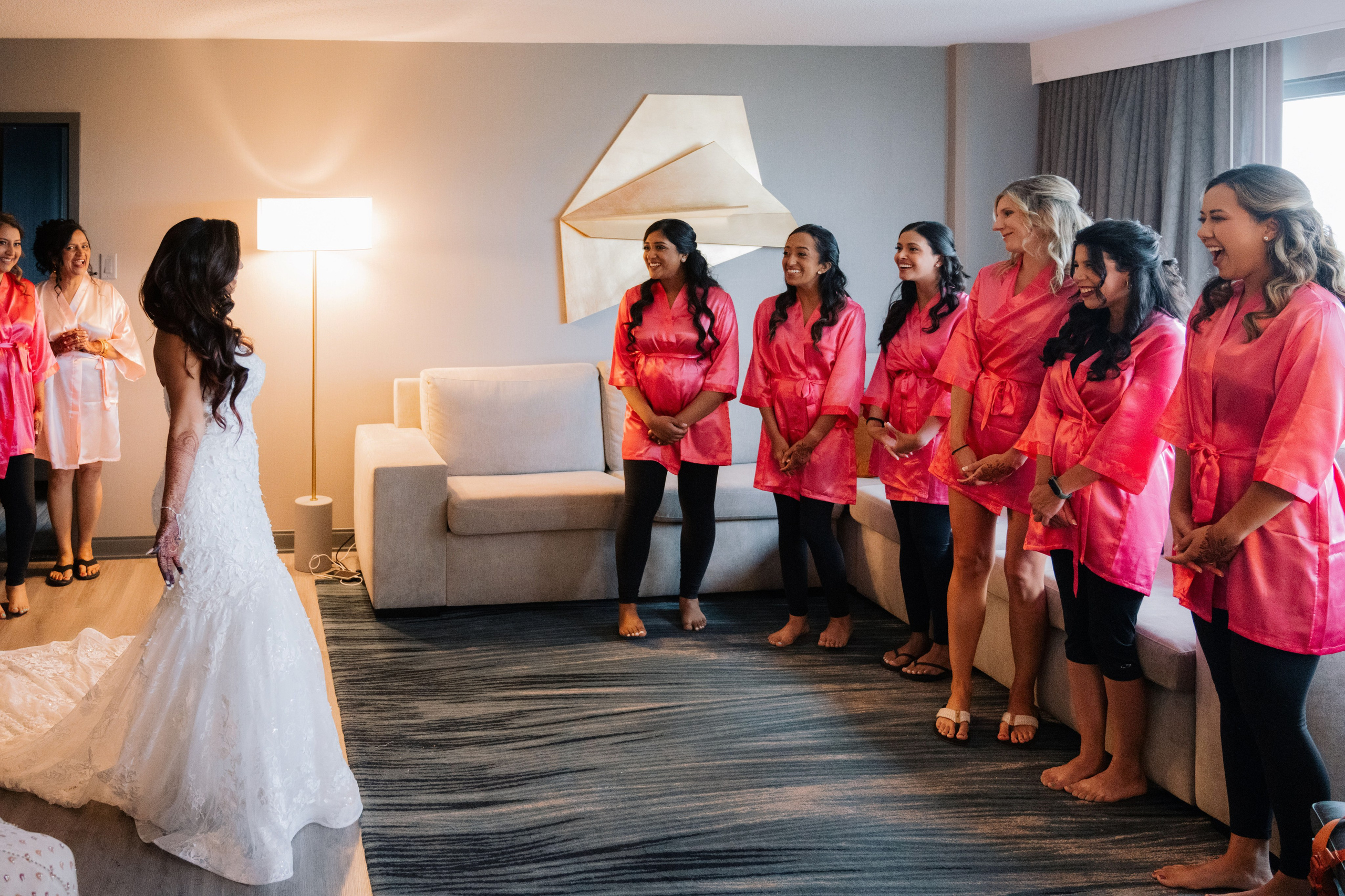 a bride and her bridesmaids in a hotel room