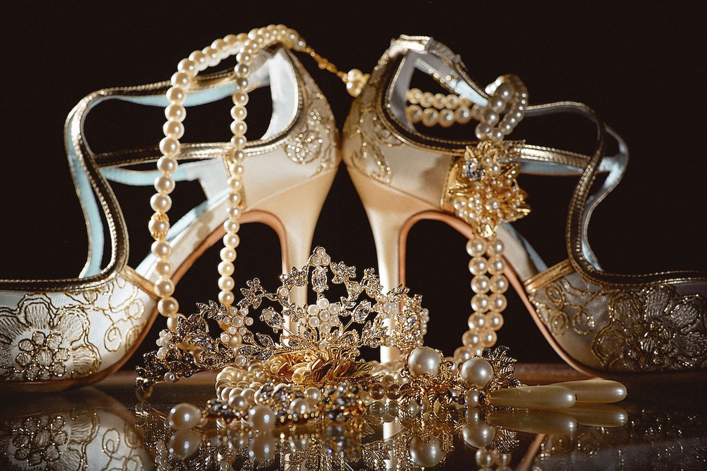 Close-up of bridal wedding accessories including shoes, tiara, necklace, and earrings at Vila Bled, Slovenia.