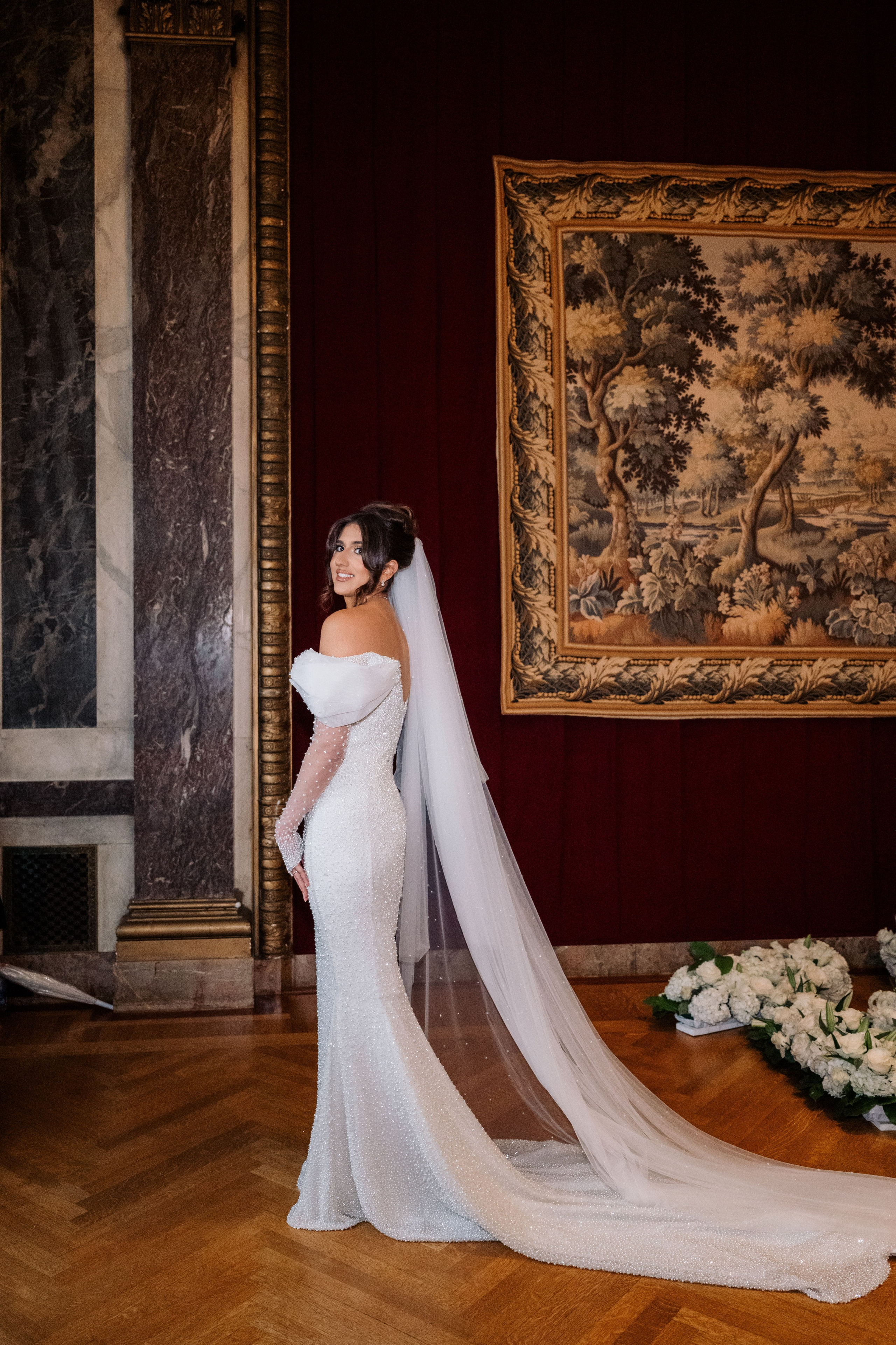 a woman in a wedding dress standing in a room