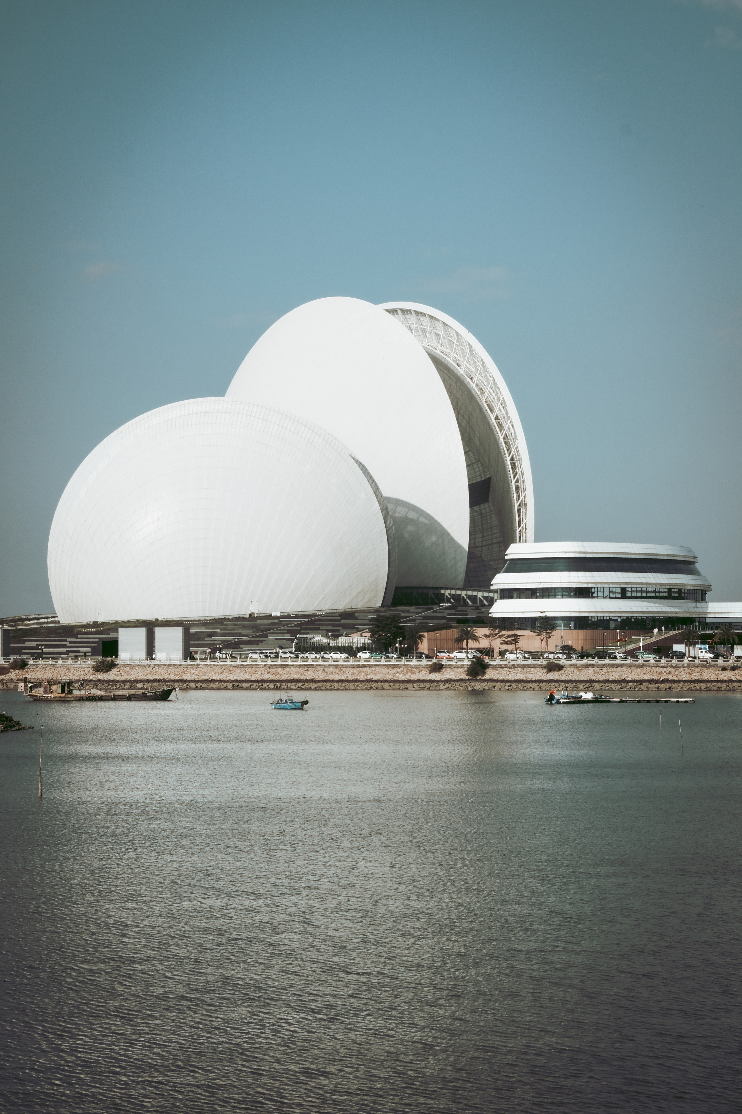 Zhuhai Opera House is located on the shores of the island in Zhuhai, Guangdong province, China, where the surging Pearl River meets the South China Sea and becomes calm.