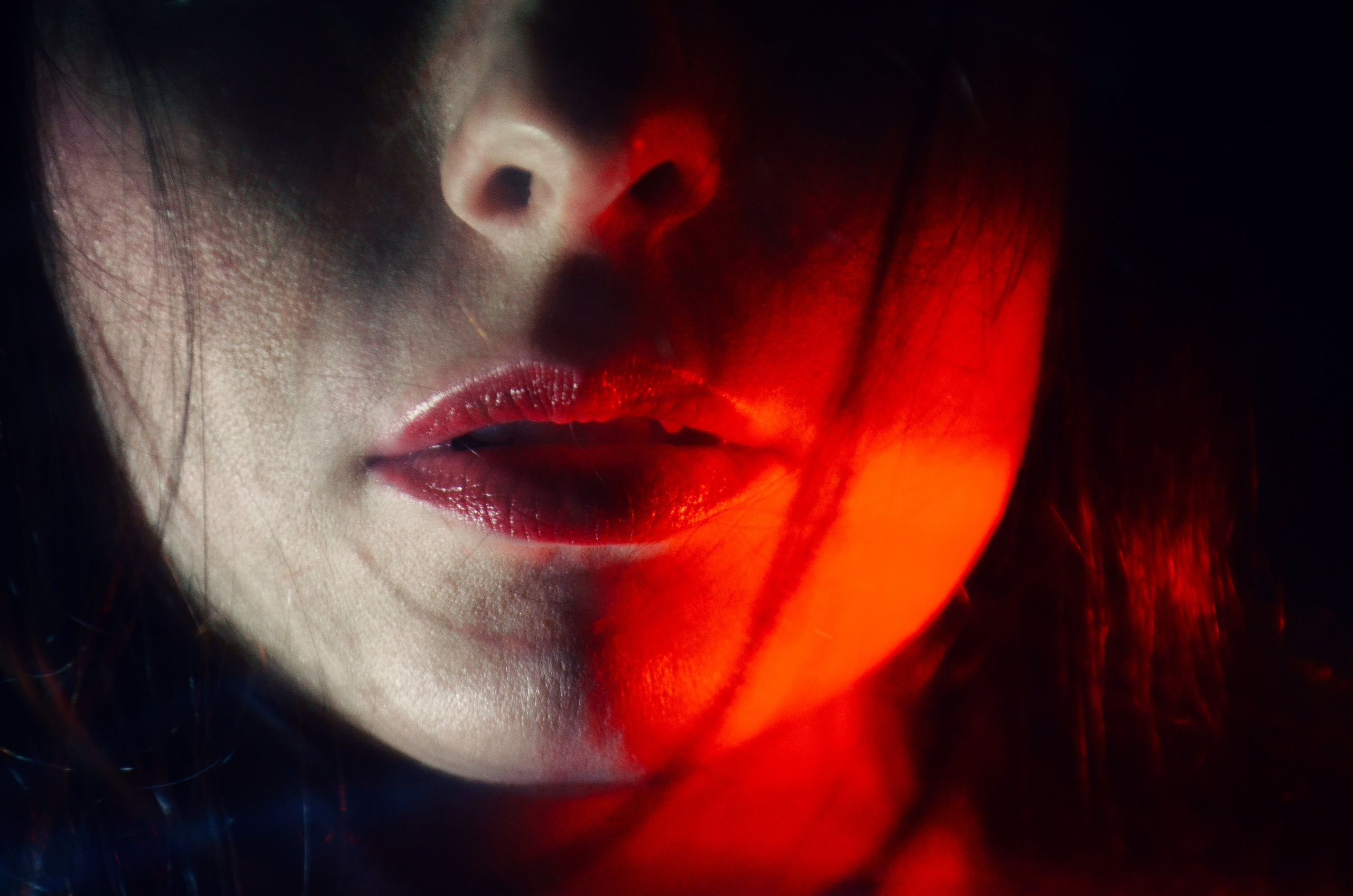 Abstract close-up portrait with dramatic red light, created during an Artistic Discovery Session in Solihull.