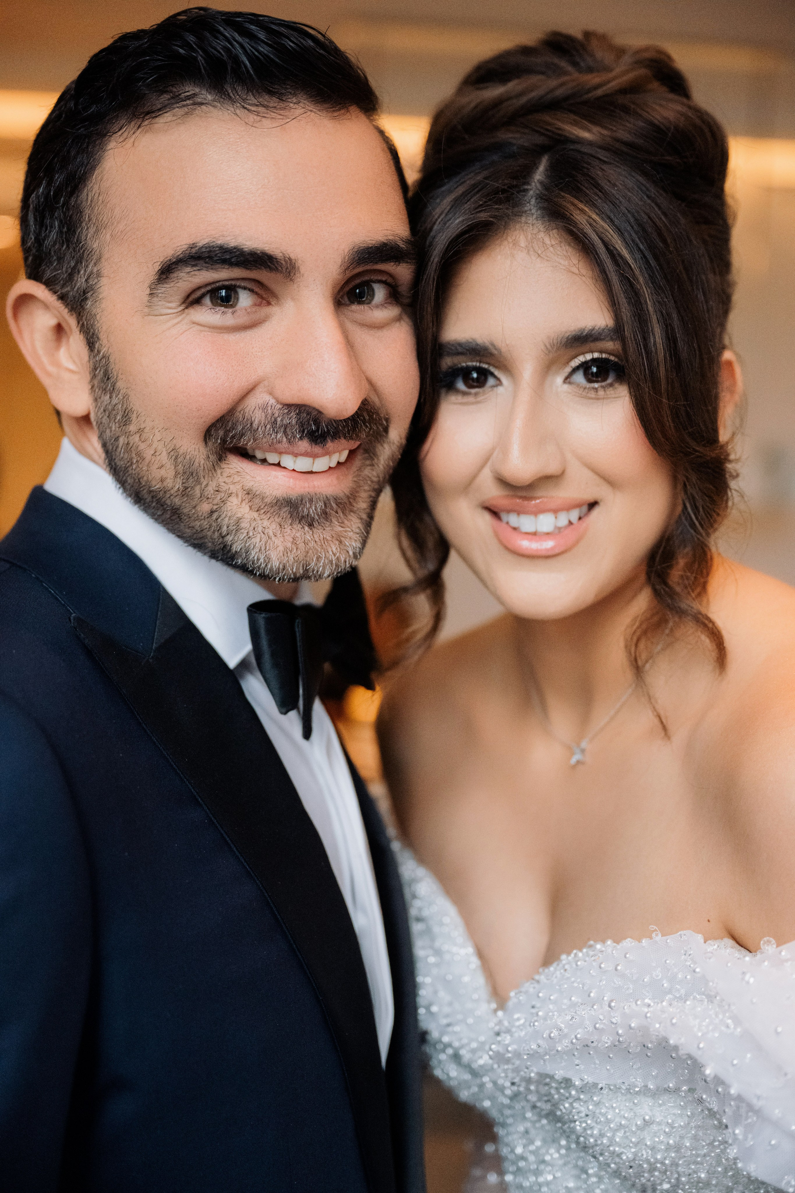 a bride and groom pose for a photo