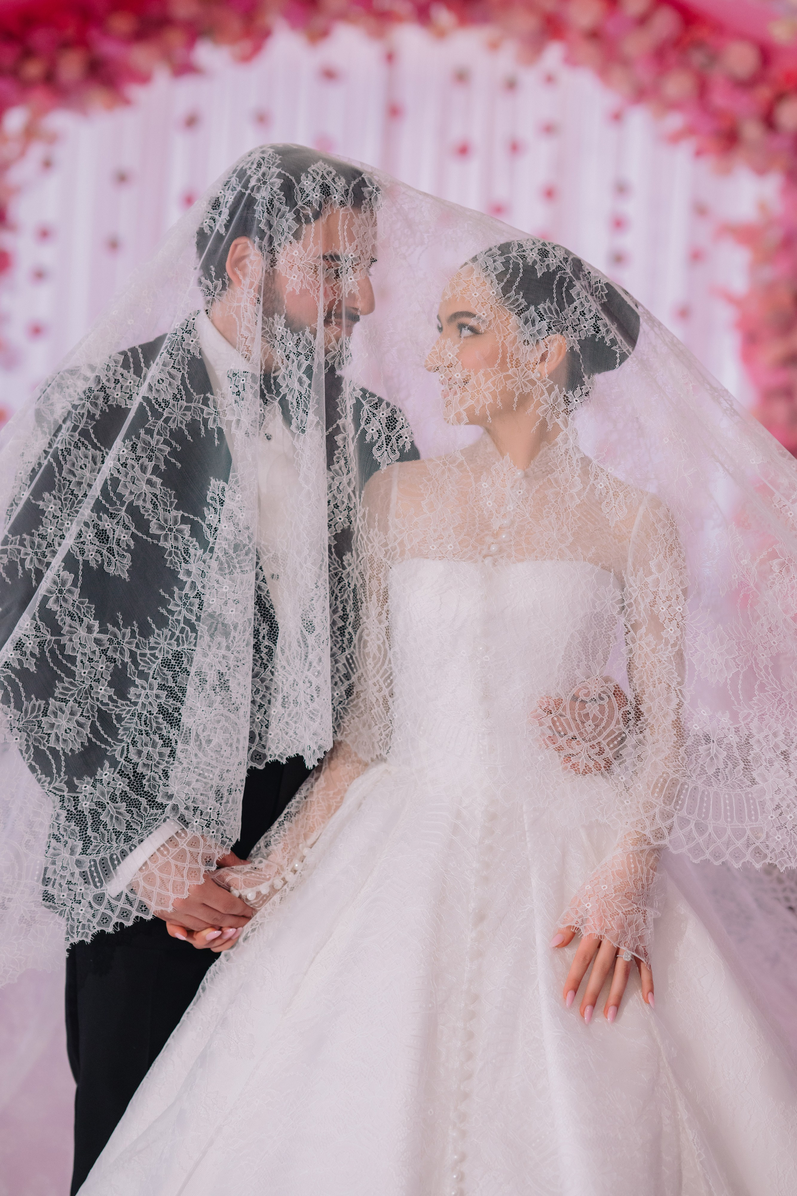 a bride and groom pose for a photo