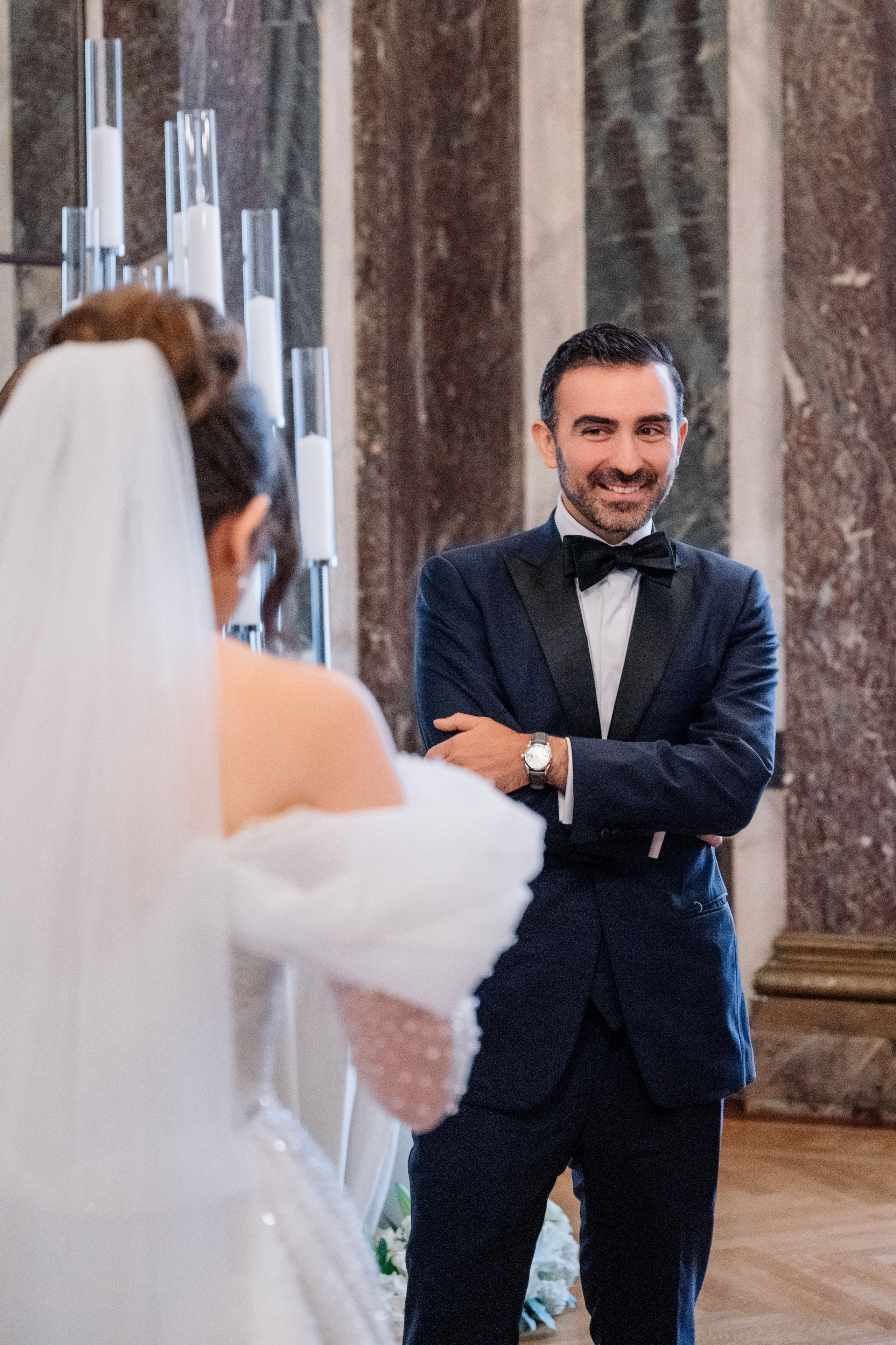a man in a suit and tie standing next to a woman in a wedding dress