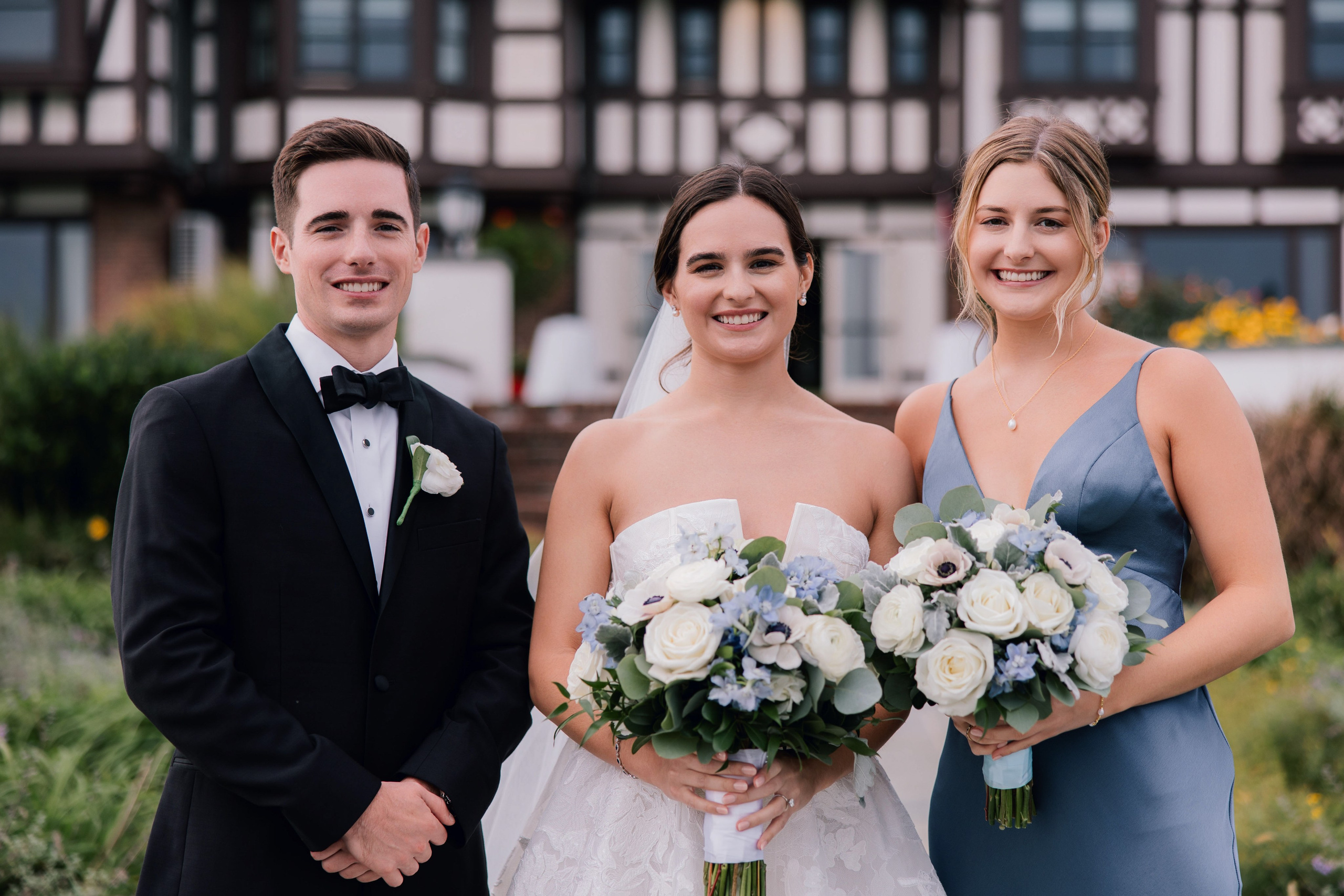 a bride and groom pose for a photo with their bridesmaids