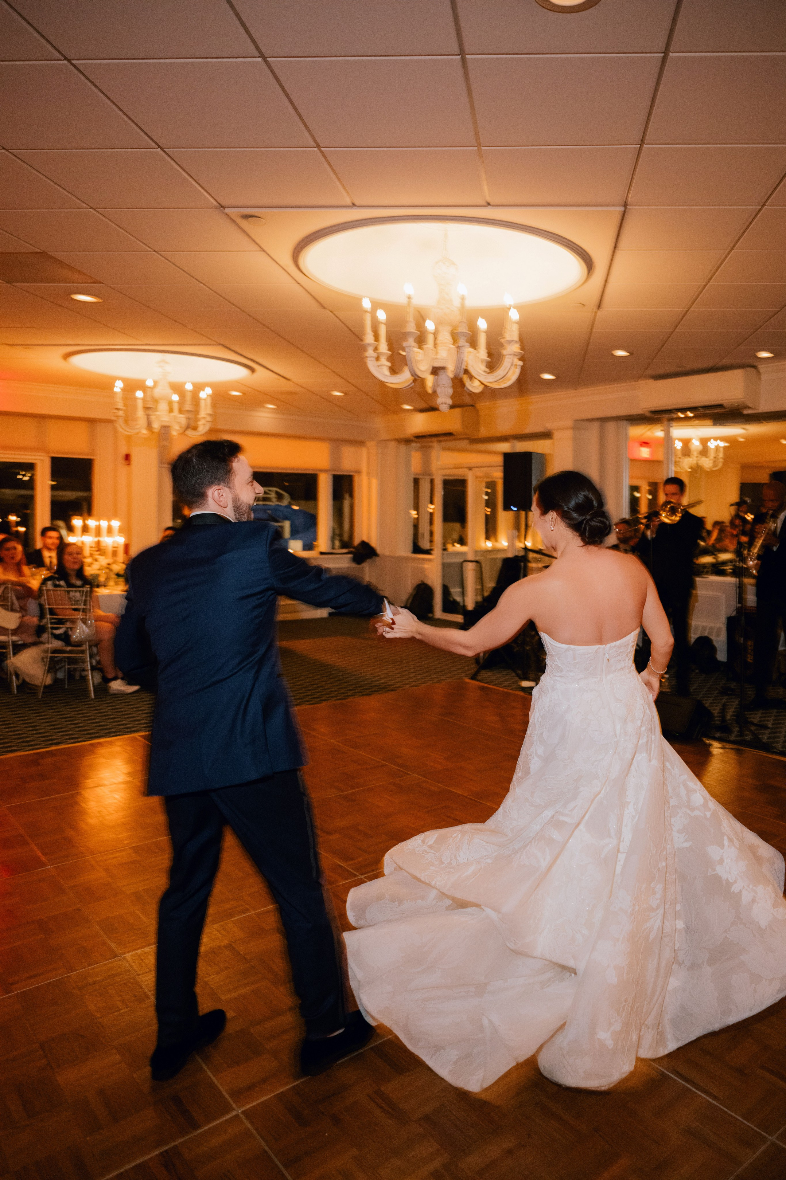 a bride and groom dancing in a ballroom