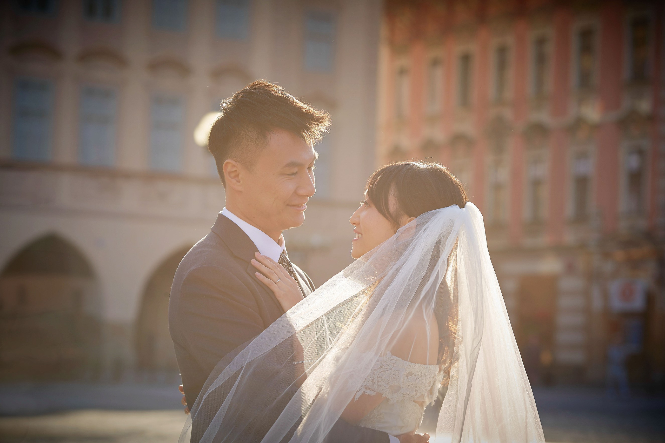 Eva and Conan are still in a romantic moment after the veil settles in Old Town Square sunlight.
