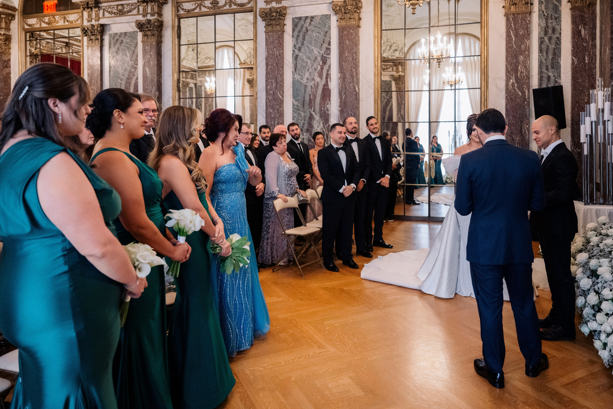 a group of people standing around a wedding ceremony
