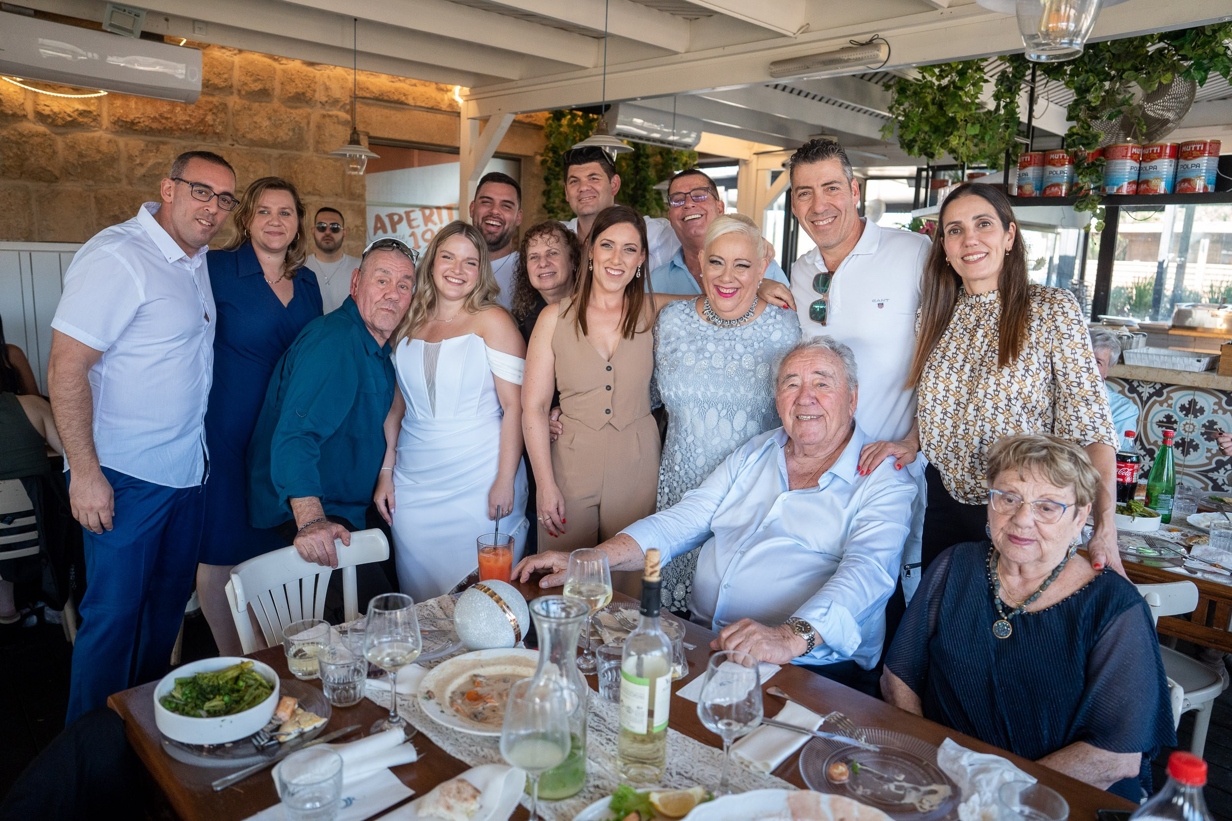 Yael and Natanel gather with their families for a group photograph