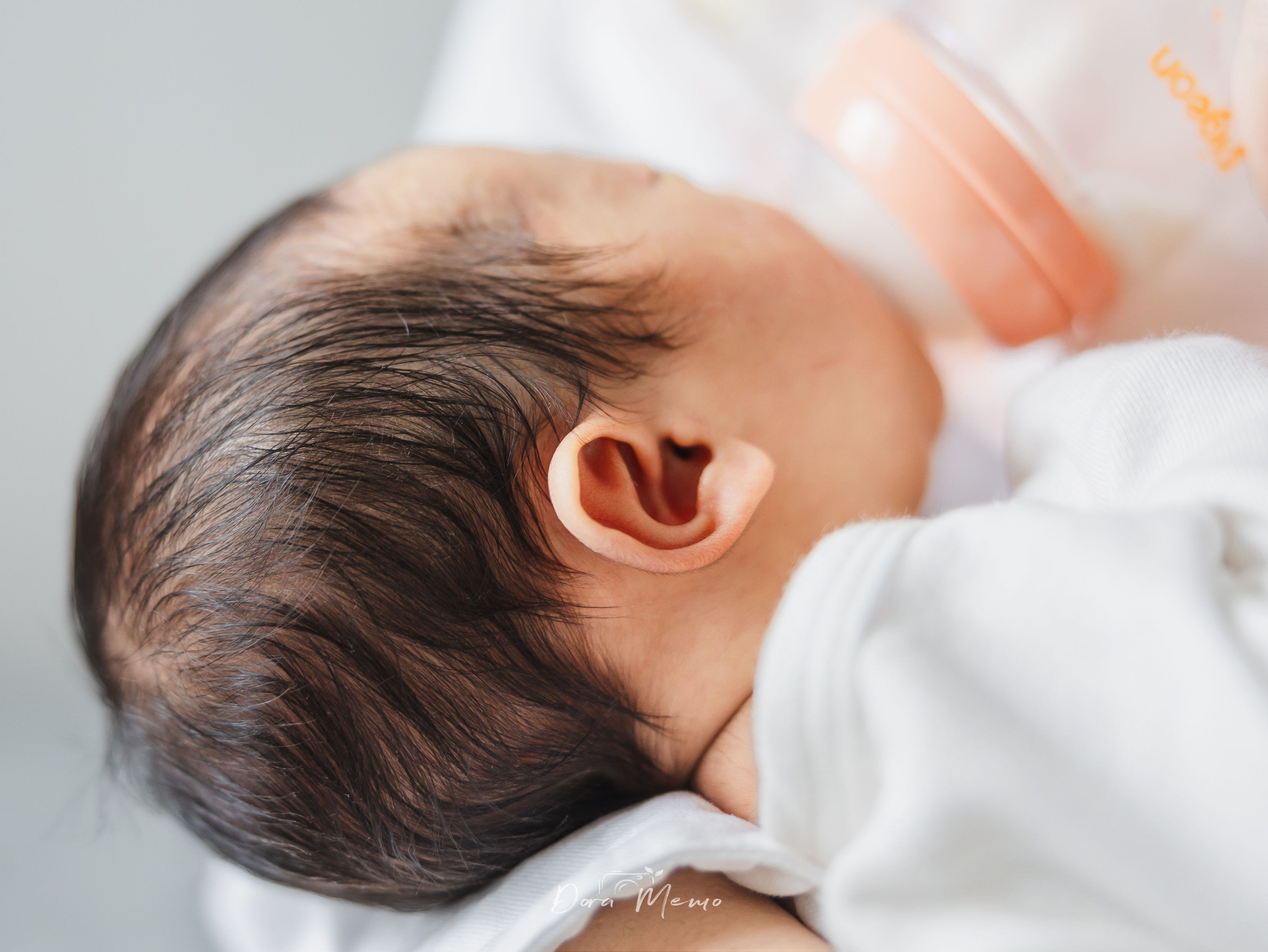 Close-up of a sleeping newborn's face, soft natural light in a Shanghai family home