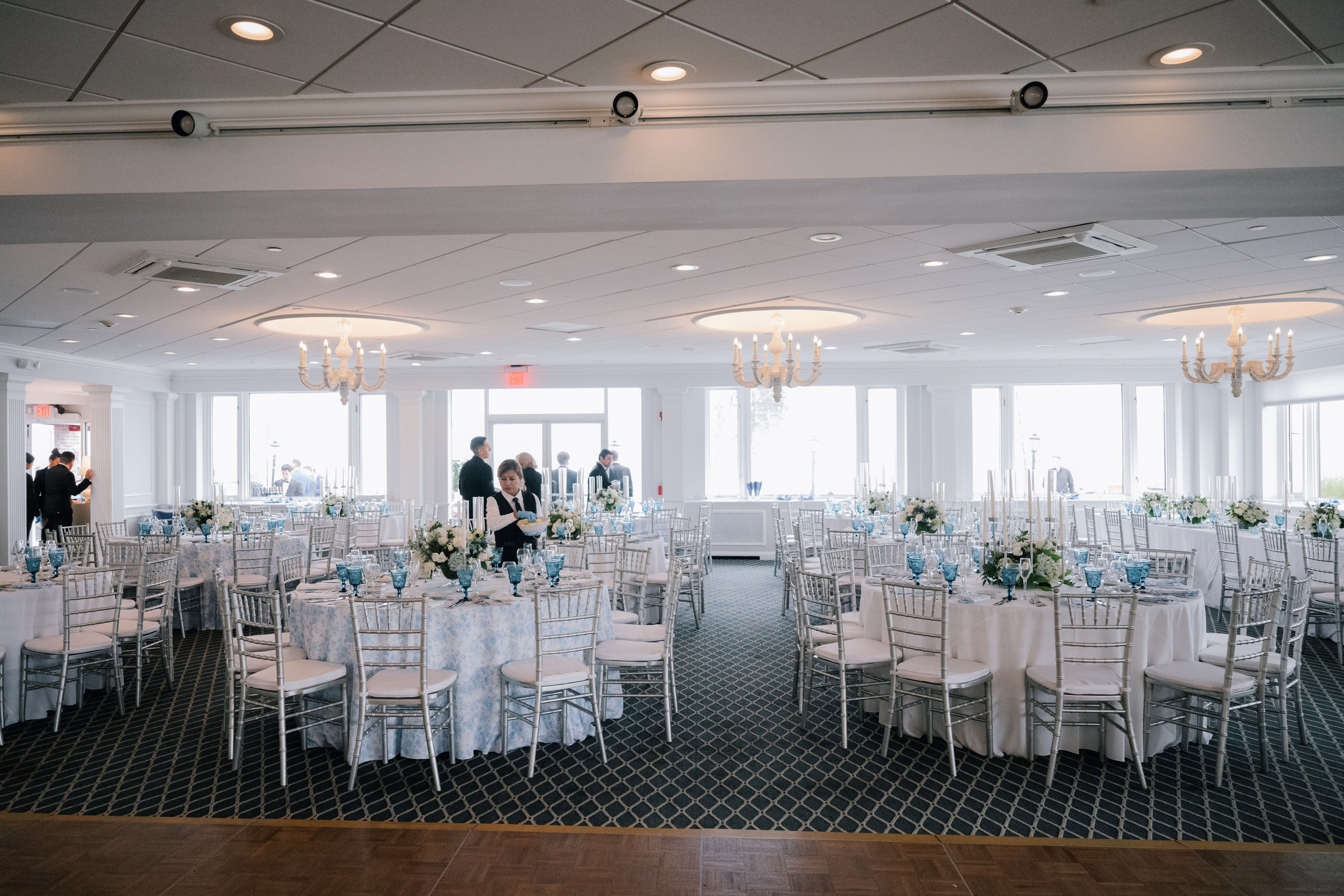 a room with tables and chairs and a couple of people
