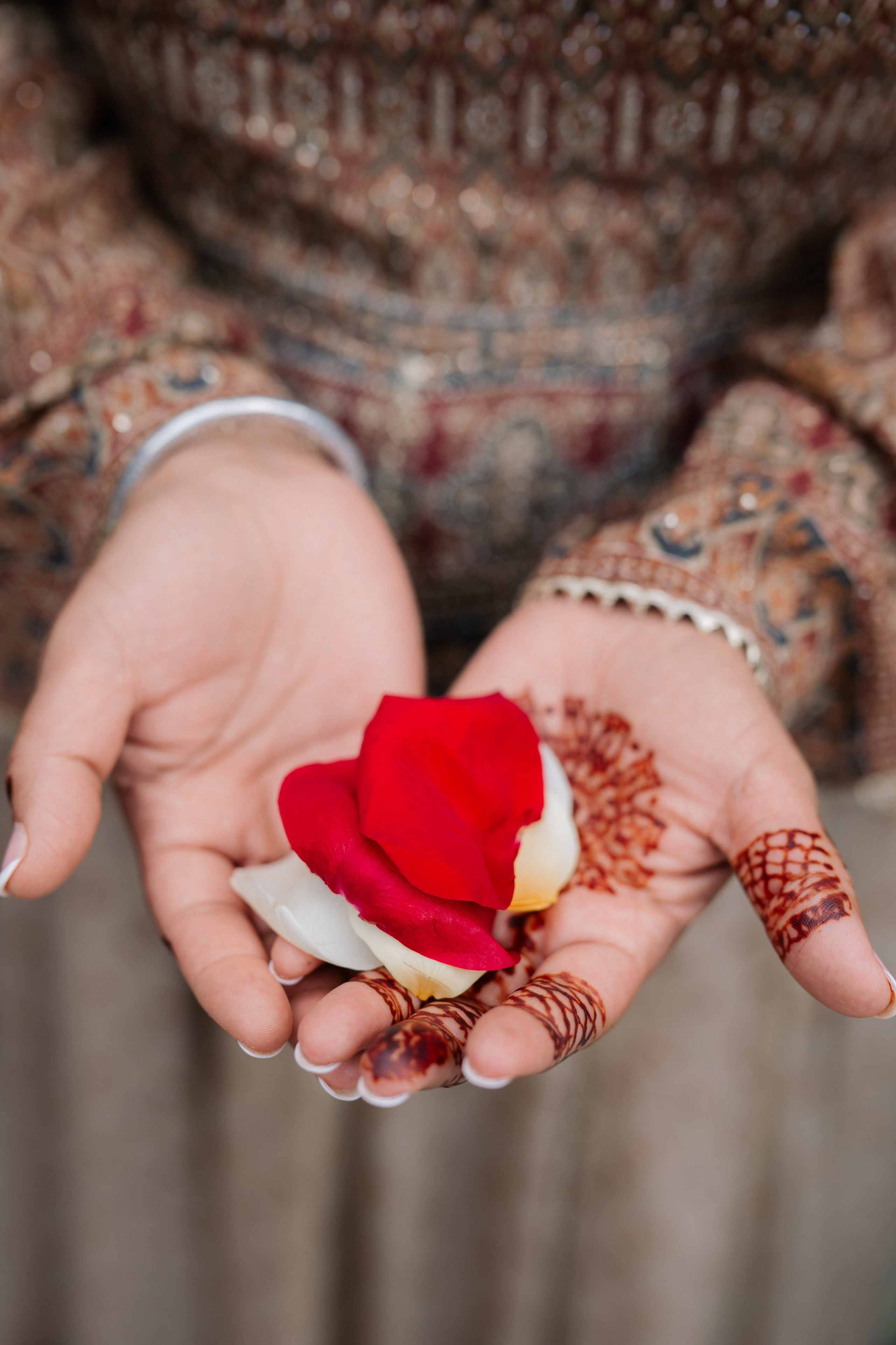a woman holding a flower in her hands