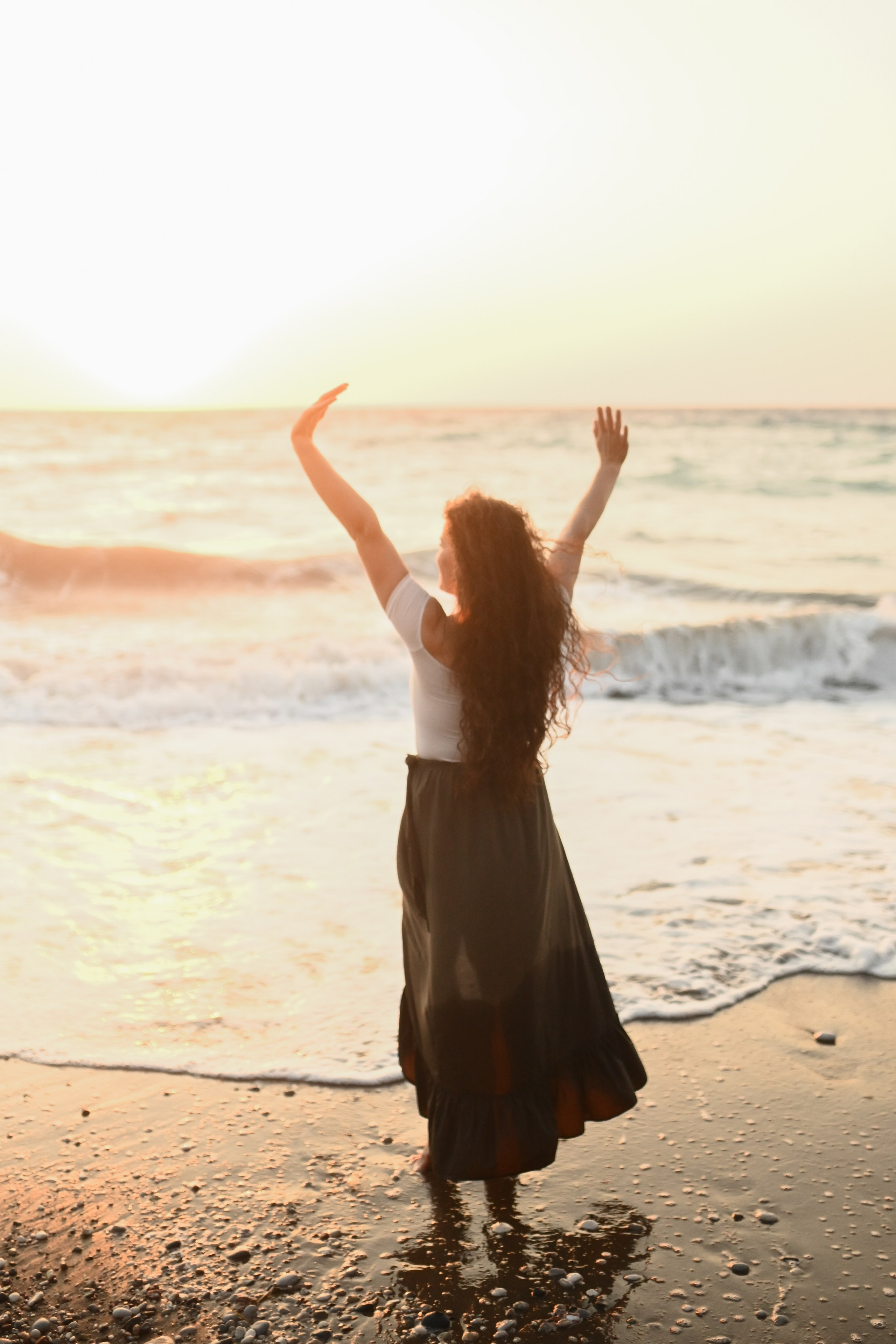 Happy family walking along a Rhodes beach at sunset. Photographer in Rhodes Island