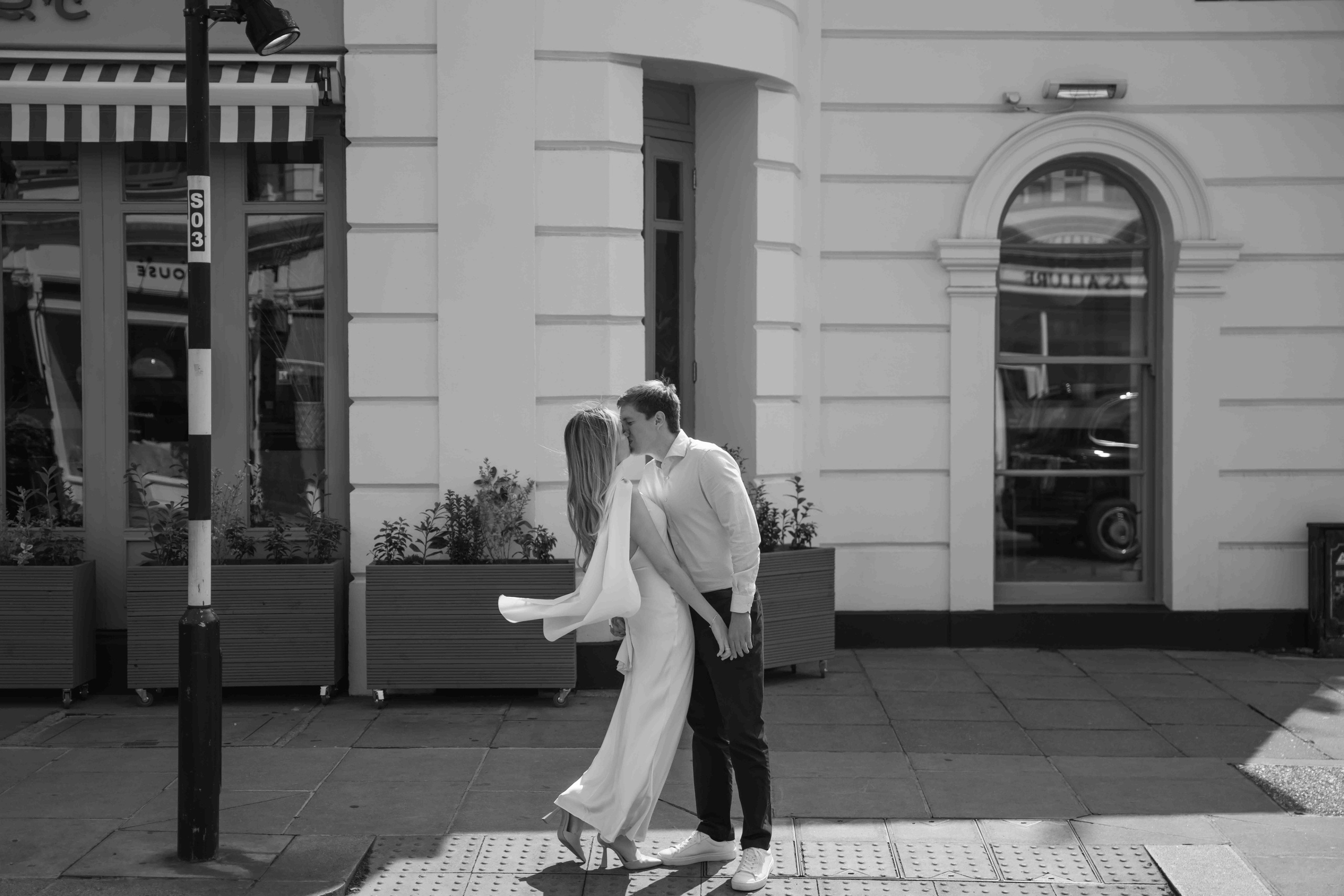 Black and white photo of a couple kissing in South Kensington London during an intimate engagement photoshoot