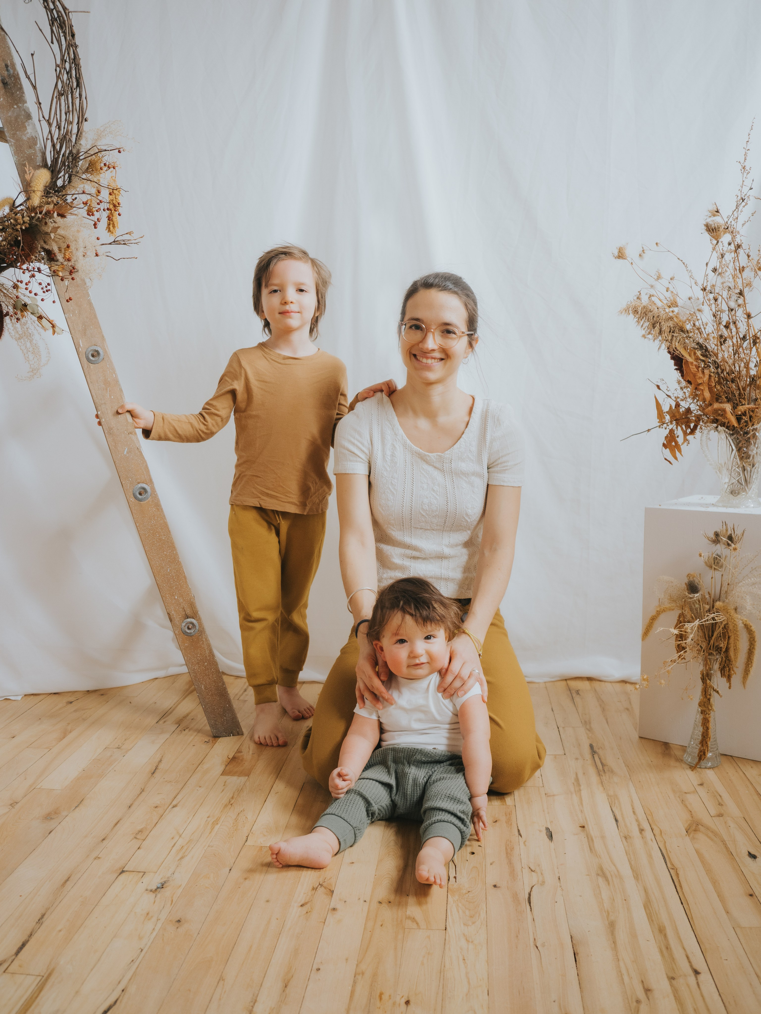 Family of three sitting in studio setting in Montreal.
