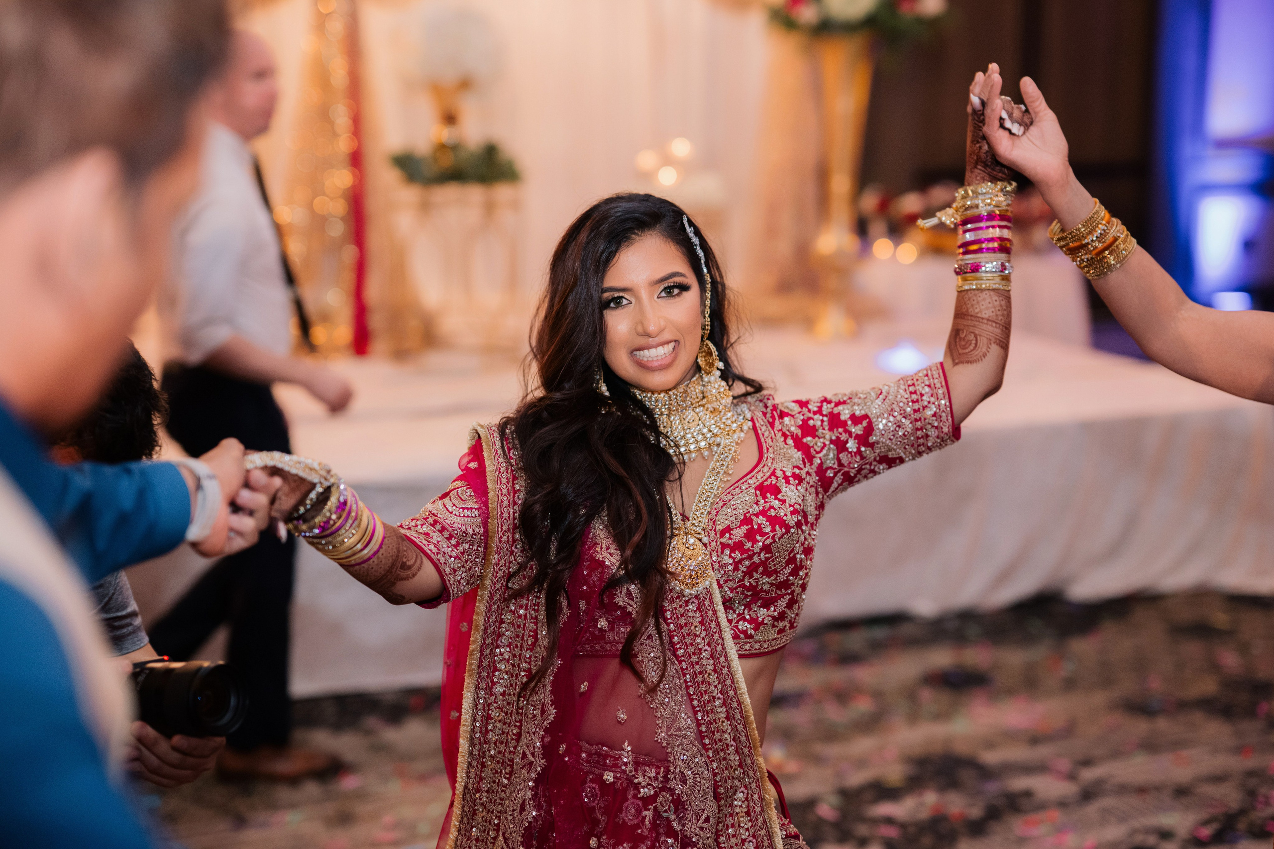 a woman in a red dress dancing with her hands up