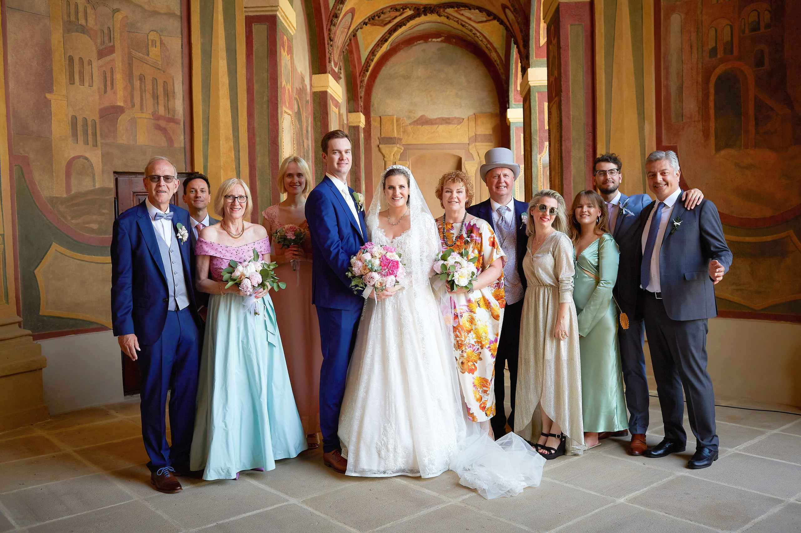 A family portrait showing the bride & groom and their parents is captured against the bacdrop of the Ledebour Garden's historic paintings.