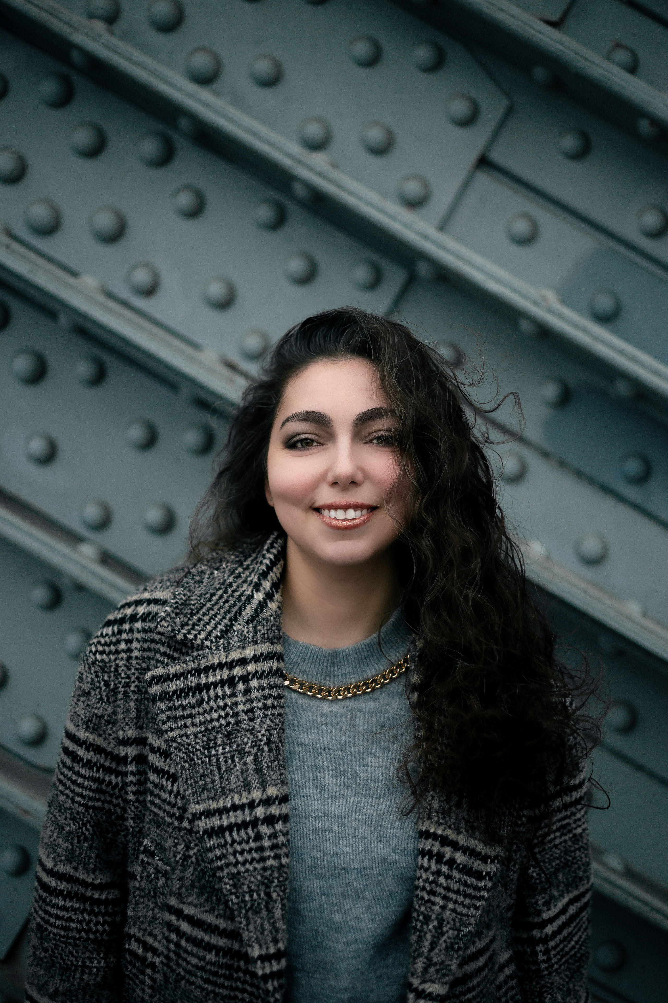 photo of a brunette on the background of a bridge